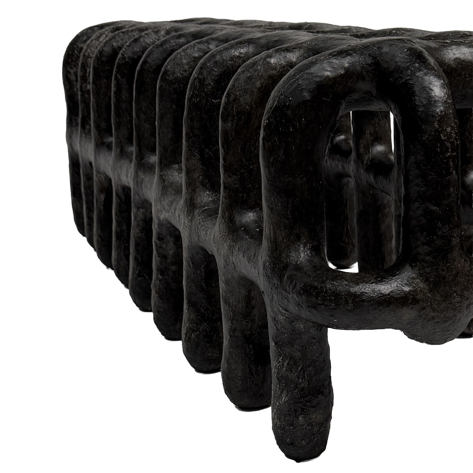Close-up of black, curved, textured sculpture with multiple arches.