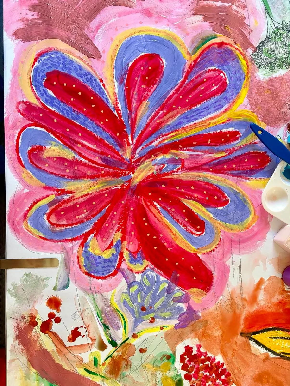 Colorful floral abstract painting featuring a large, vibrant red flower with purple and yellow accents, with a pink background and additional smaller flowers and splashes of paint around it.