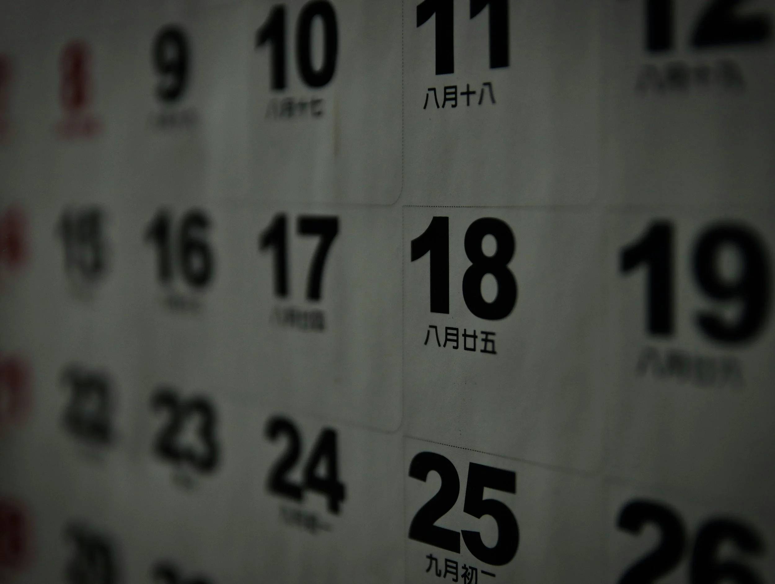 Close-up of a calendar showing dates in September, October, and November with Chinese characters indicating months and days.