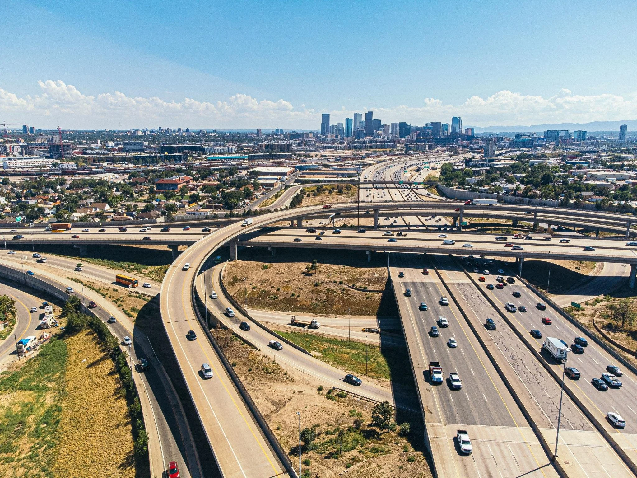 Denver highway system and city skyline representing local courier and delivery service.