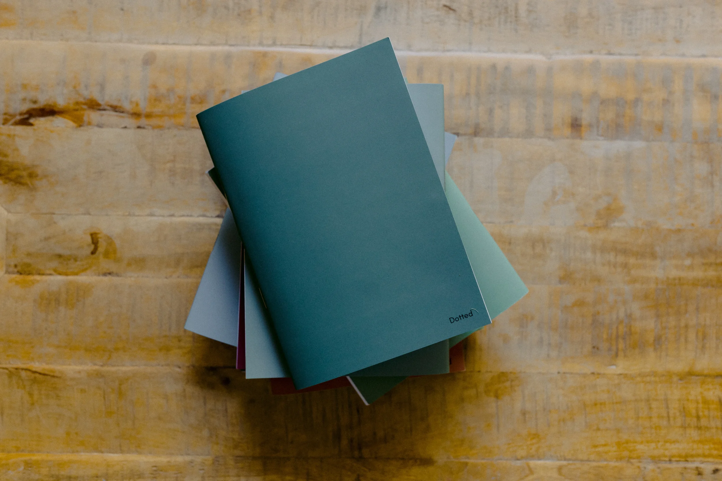 Stack of sample cards in different colors on wooden surface