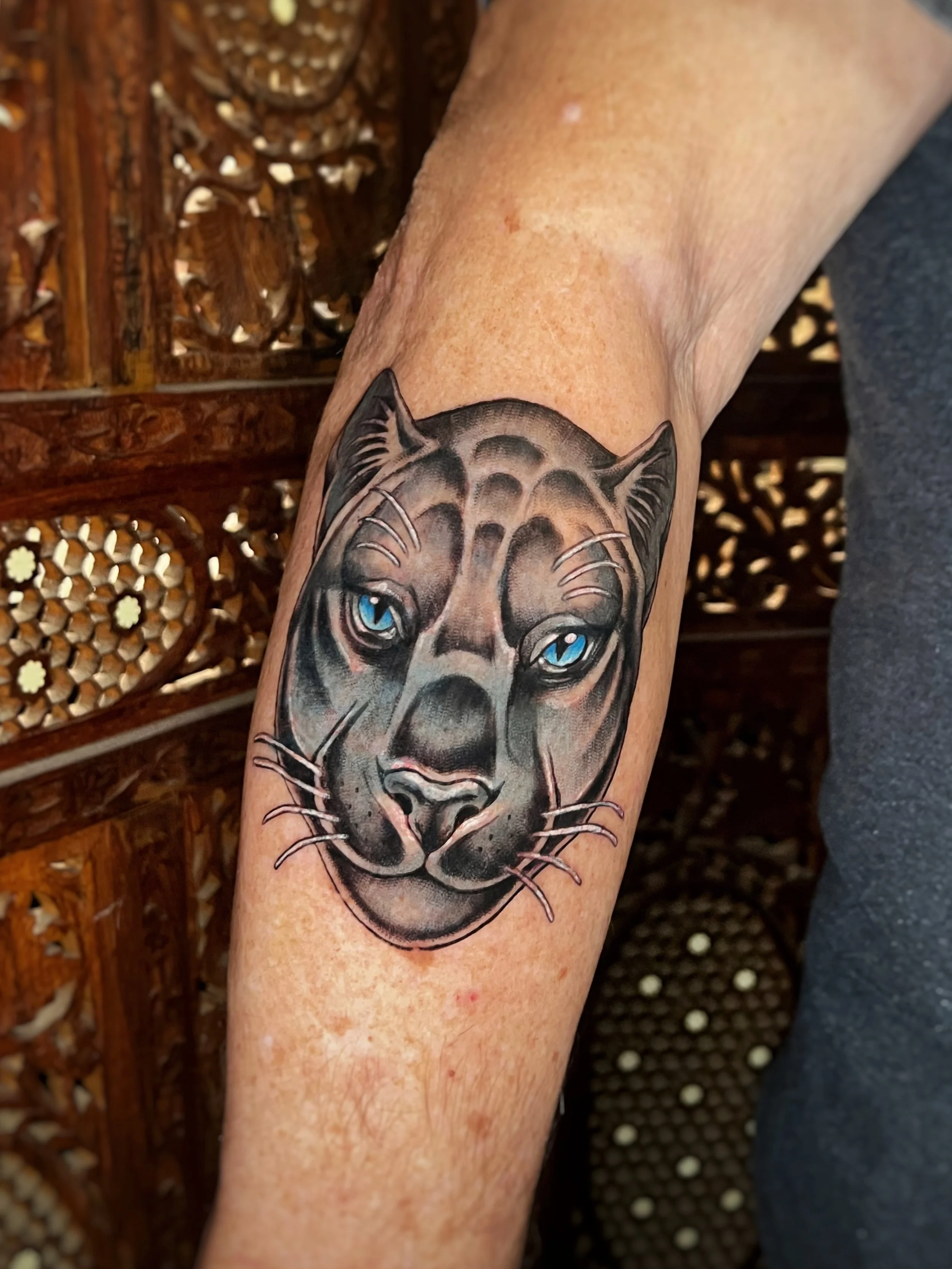 Illustrative tattoo of a panther face