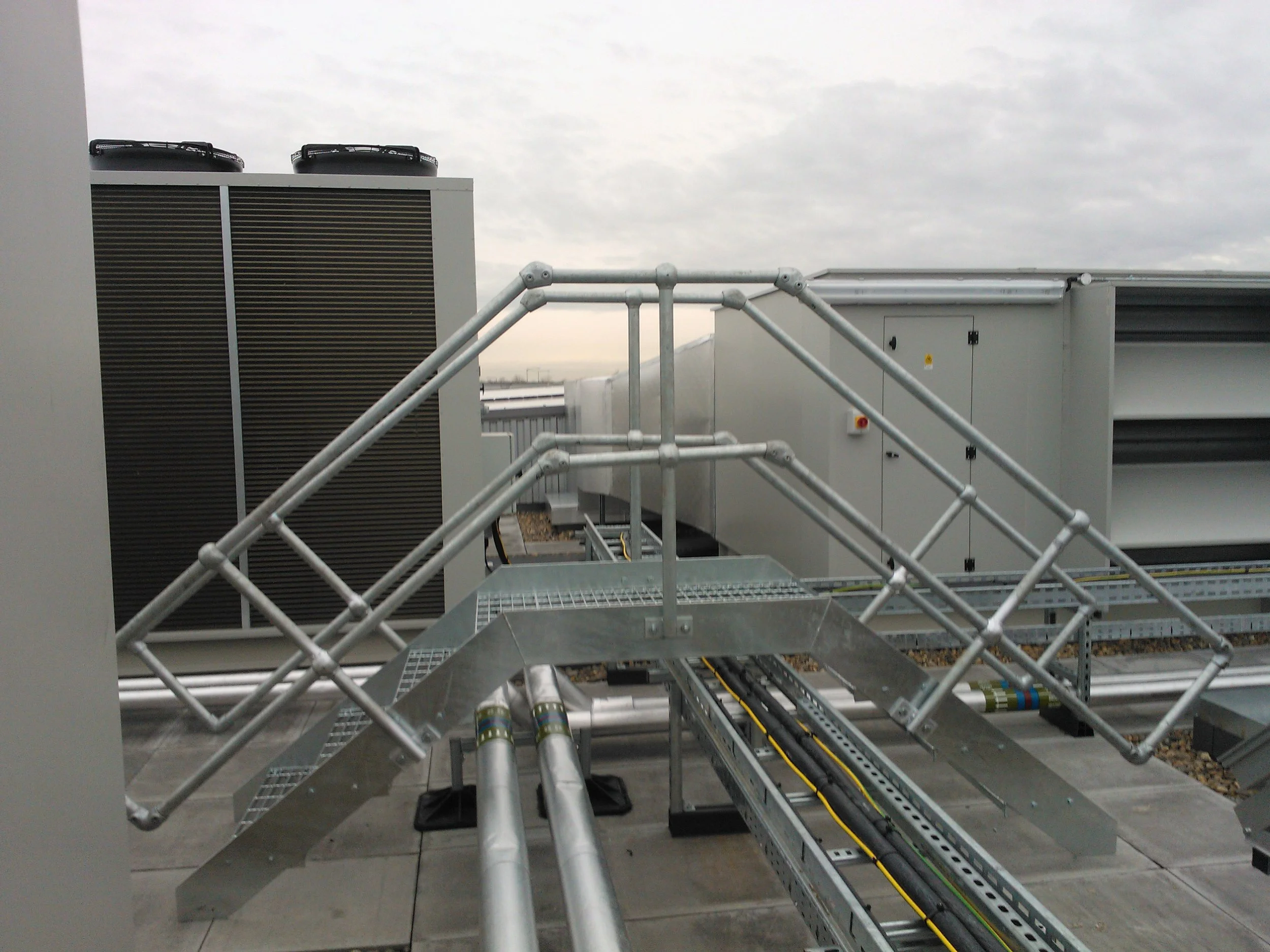 Galvanised steel step over platform with handrails