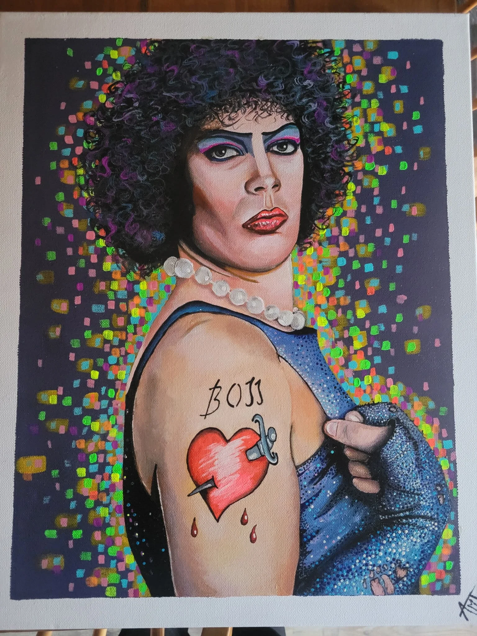A painting of a person with curly hair, dramatic makeup, and a pearl necklace. They have a tattoo of a broken heart with a syringe on the chest and a tattoo of a small heart with a tear on the arm. The background is filled with colorful square and re