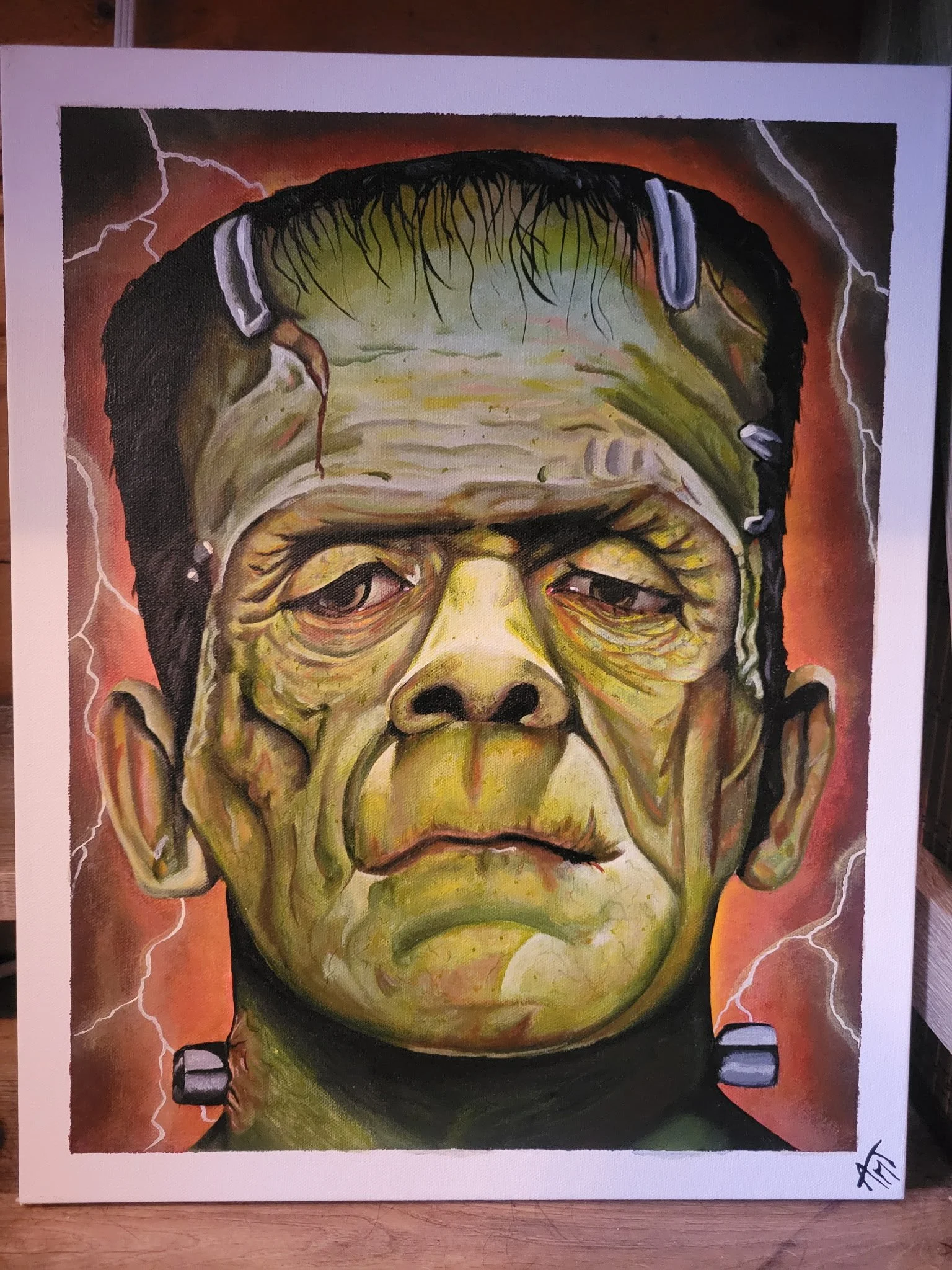 Painting of Frankenstein's monster with characteristics of a zombie, featuring greenish skin, black hair, and a bolt on the side of the head, surrounded by lightning bolts.