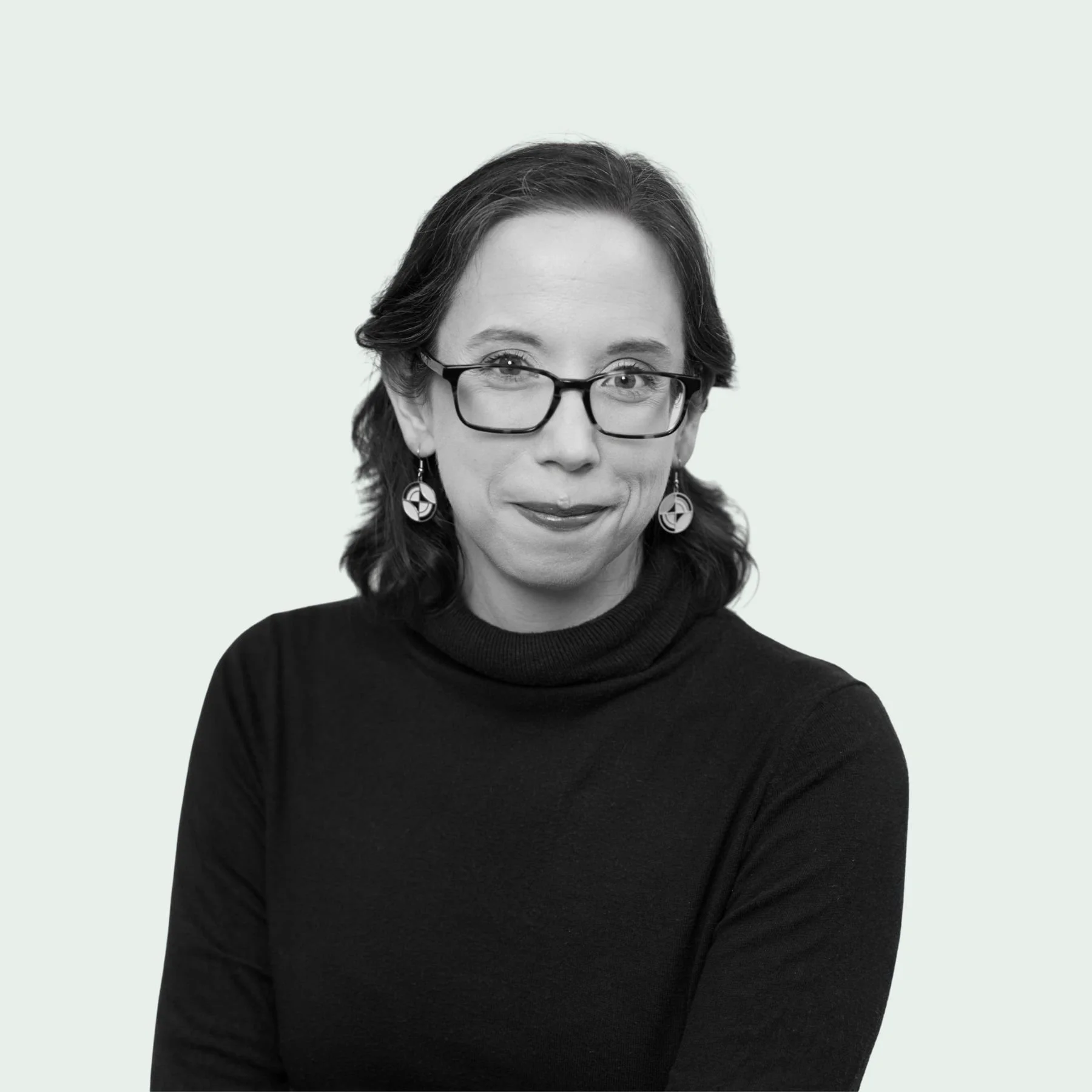 Thought partner Alex Hughes Capell wearing dark sweater and glasses.