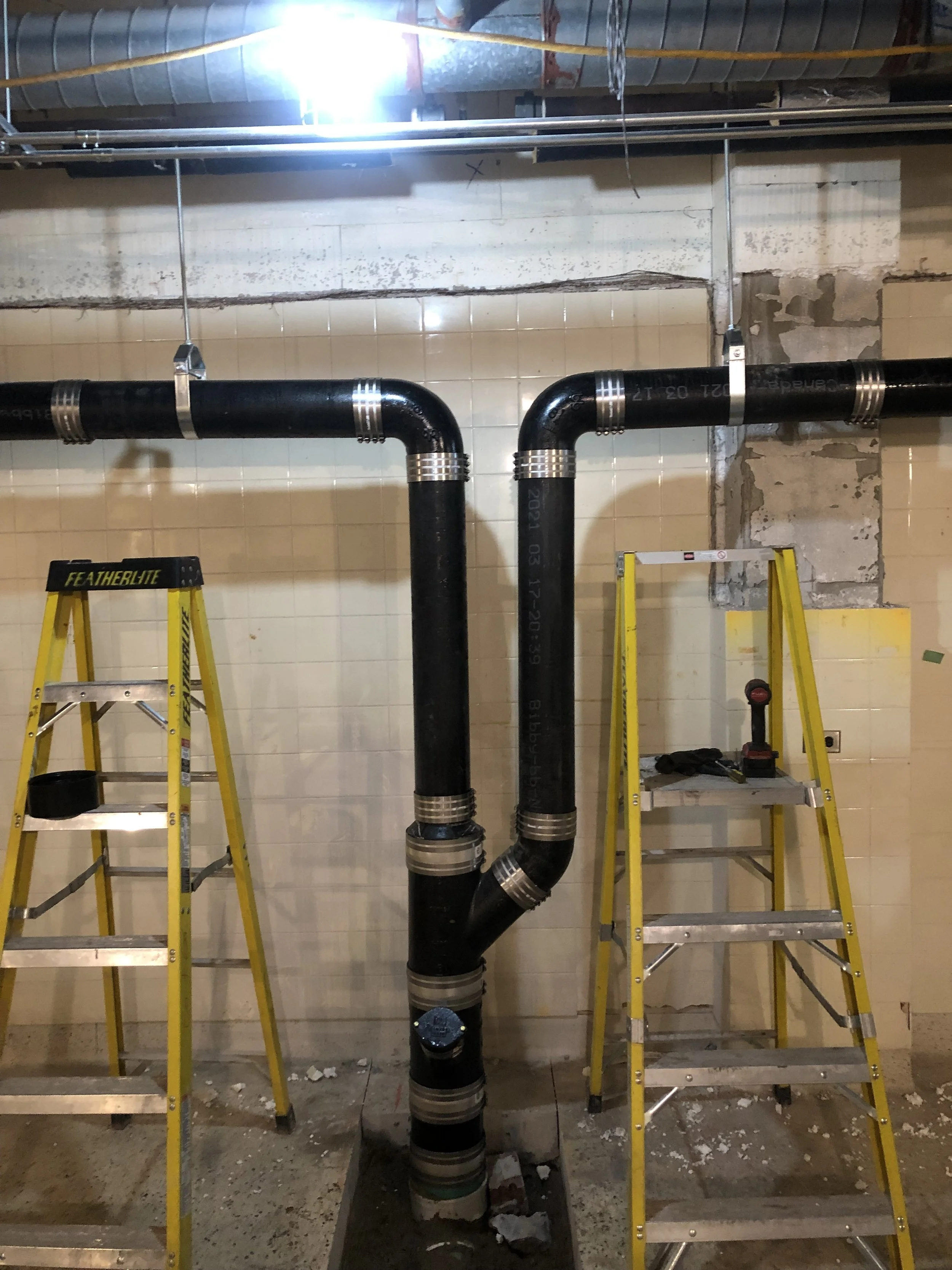 Cast Iron Drain lines connected in the basement of our latest building under construction.