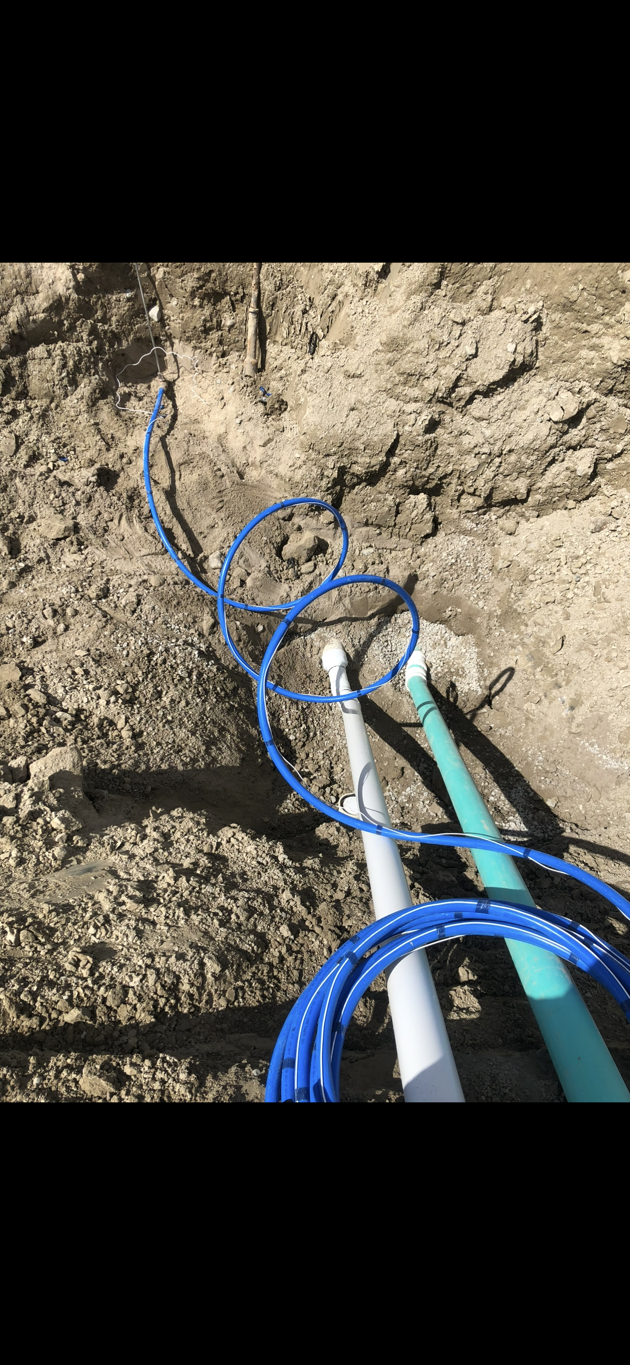 Underground Sewer Drain, Storm Drain & 1" Water service line on a construction site.