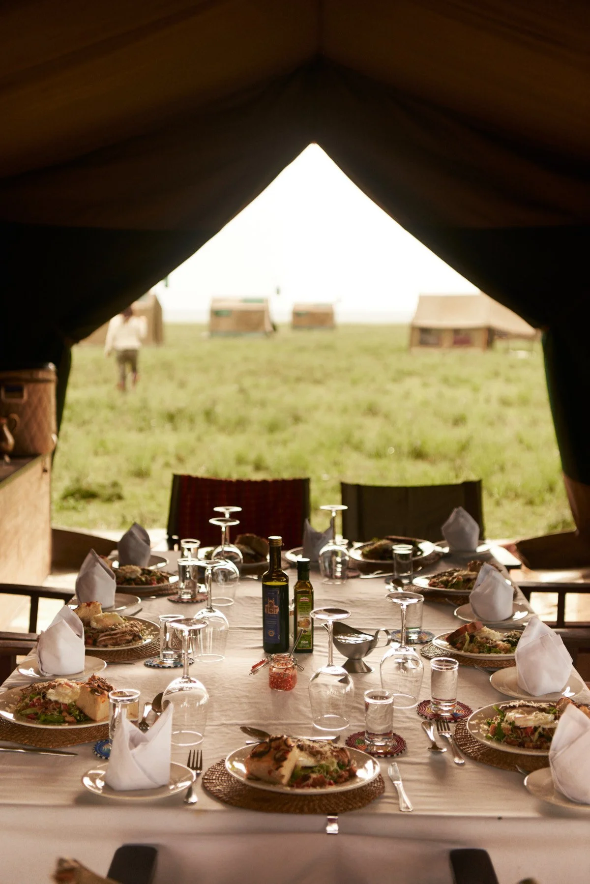 Dinner table laid in the mess tent at the mobile camp