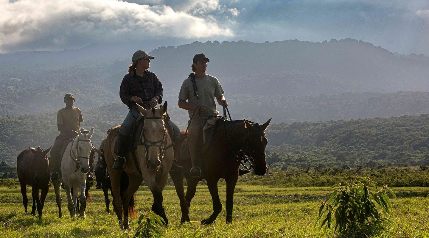 Horse safari riders on the slopes of Mount Meru, Tanzania