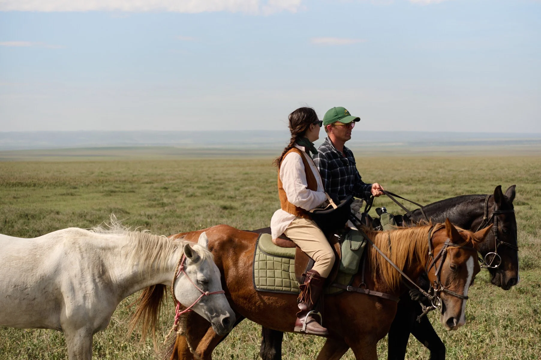 Riders and horses on the Serengeti plains