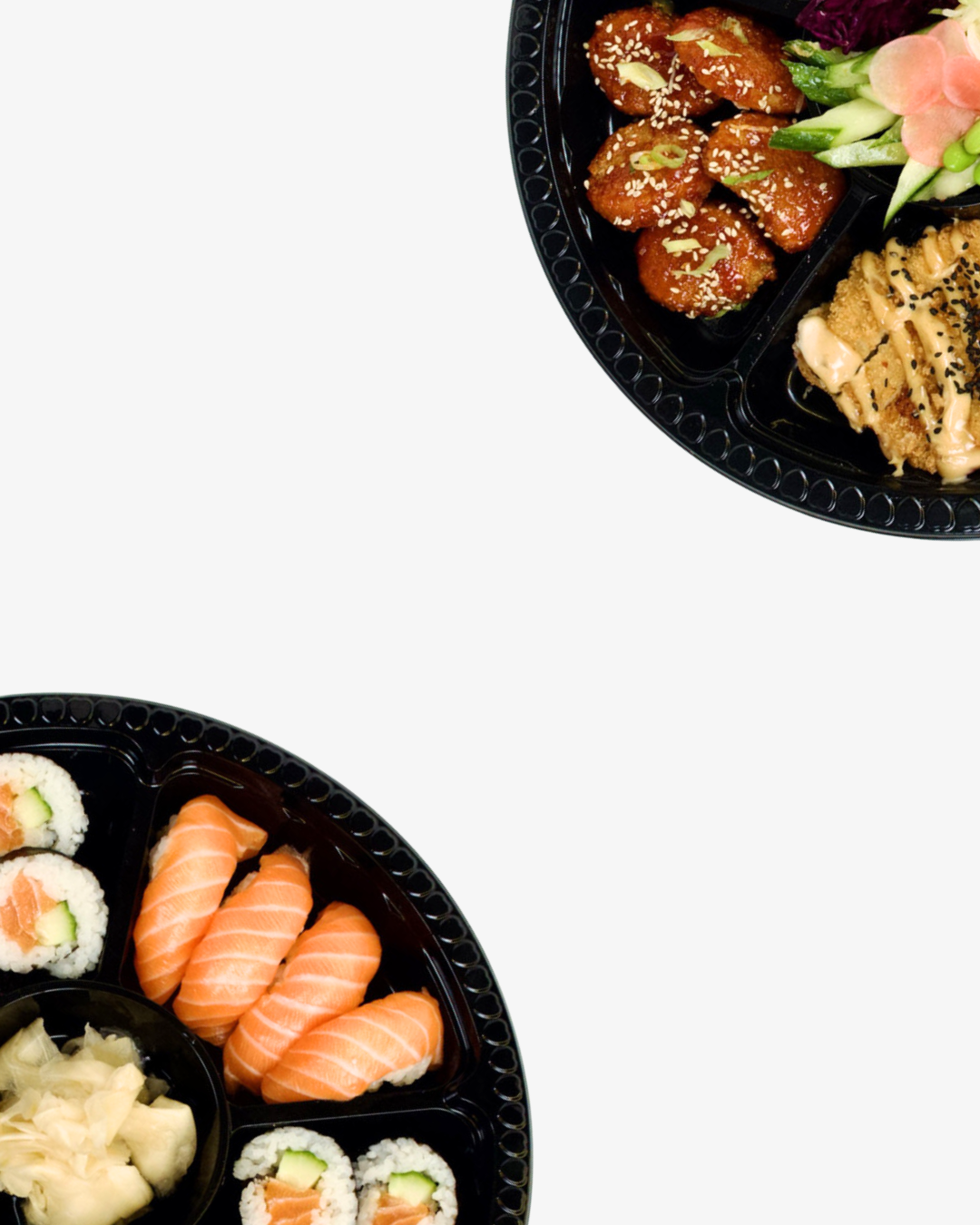 Two black plastic sushi trays with assorted sushi, including salmon rolls, nigiri with salmon, fried chicken wings with sesame seeds, and fresh vegetables.