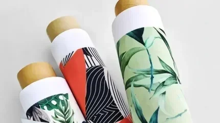 Three rolled-up paper towels with botanical, geometric, and abstract patterns