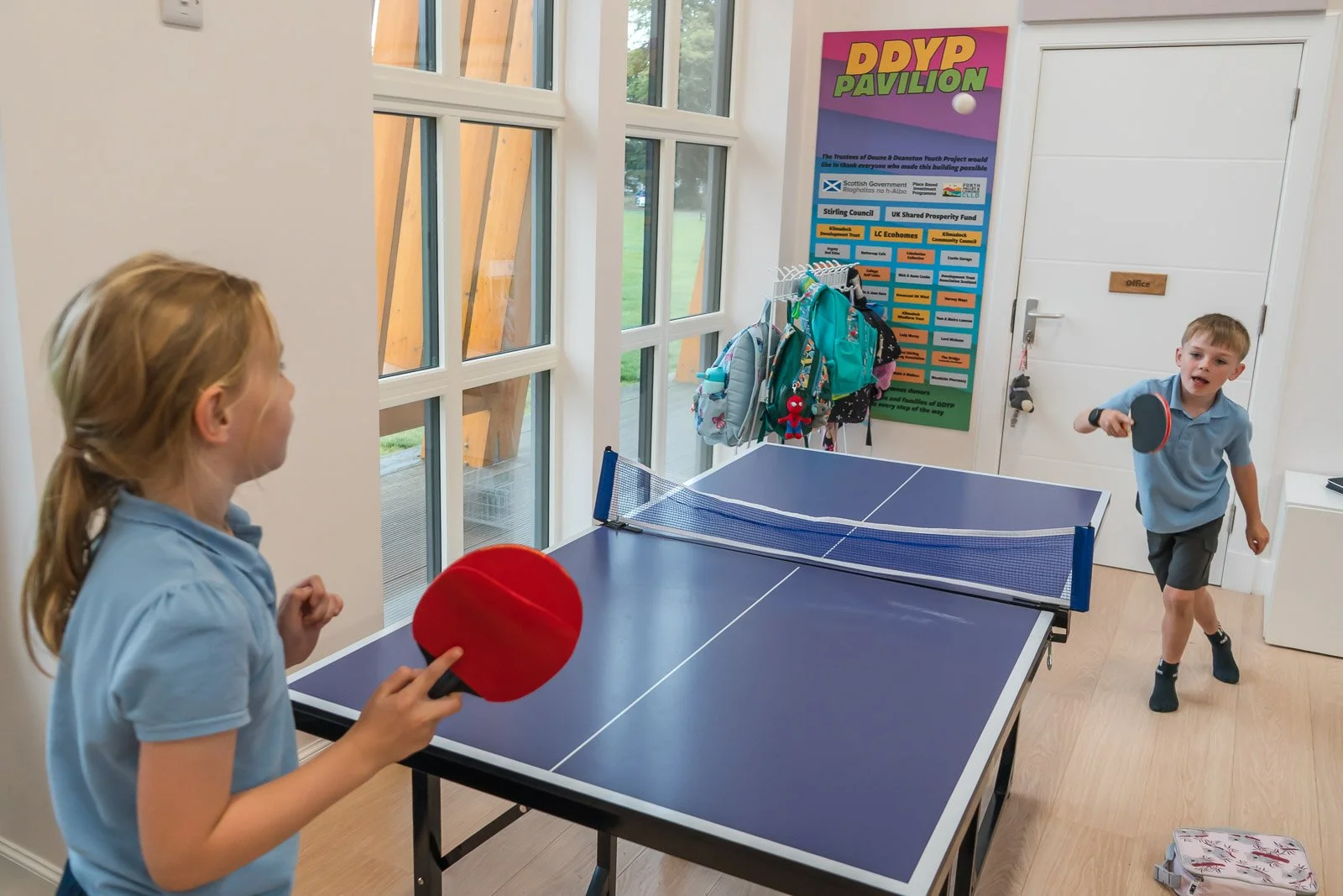 Two children playing table tennis in the DDYP pavillion in Doune at the after schools club.