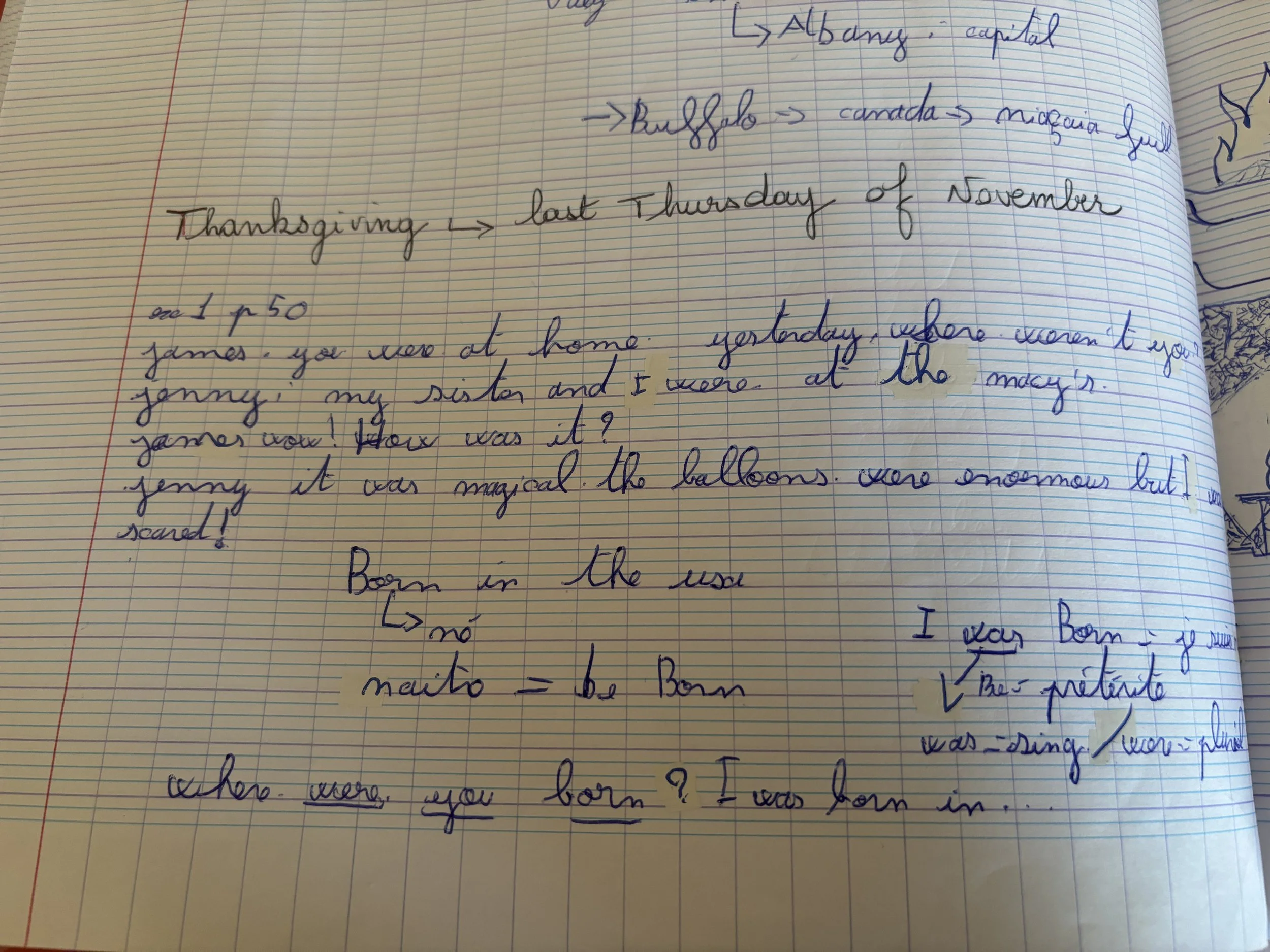 Une page de cahier avec des notes écrites à la main en différentes couleurs, principalement en bleu et noir, avec un dessin en bas à droite.