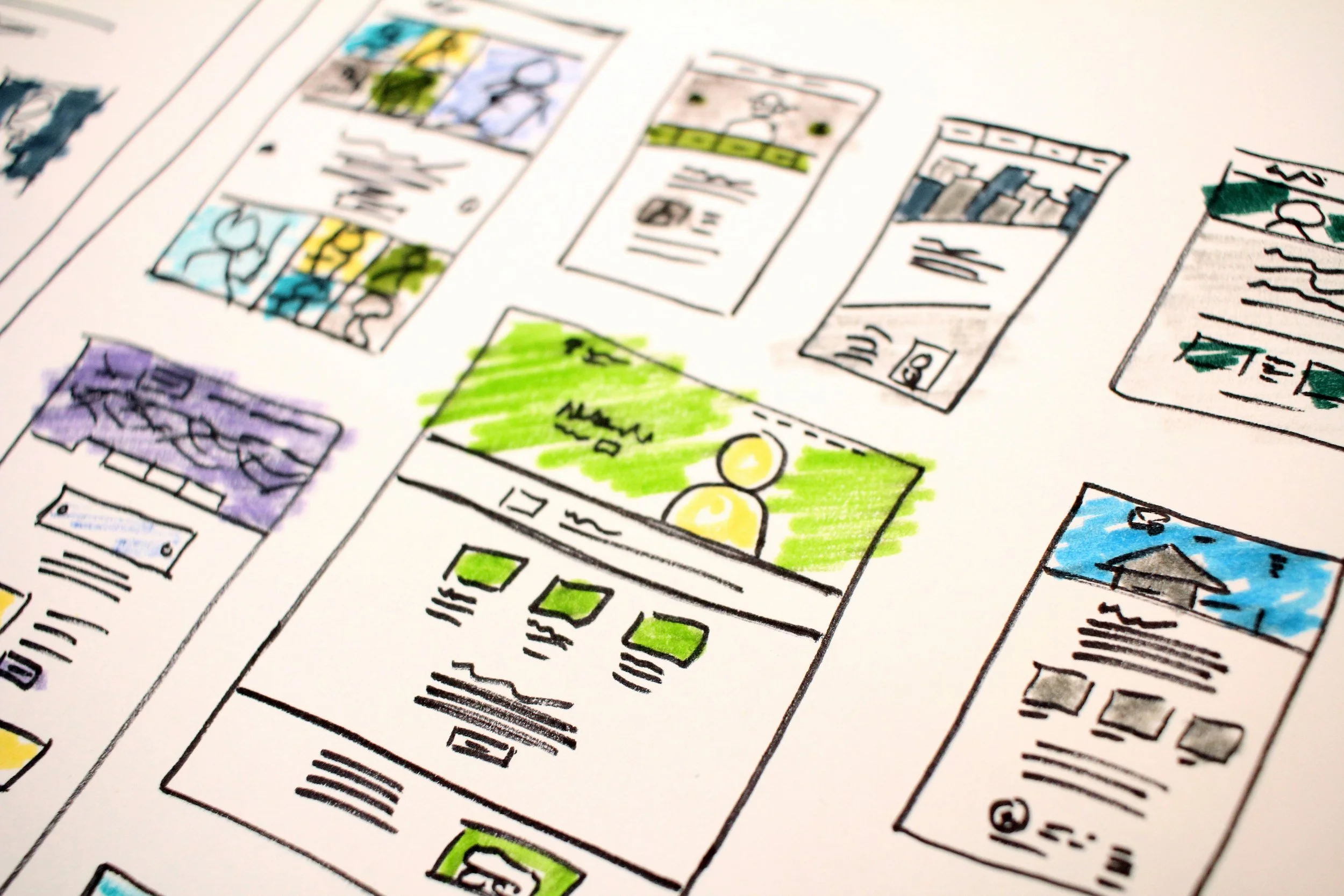 A colorful hand-drawn storyboard or comic strip with various panels, some colored with markers, depicting different scenes and ideas.