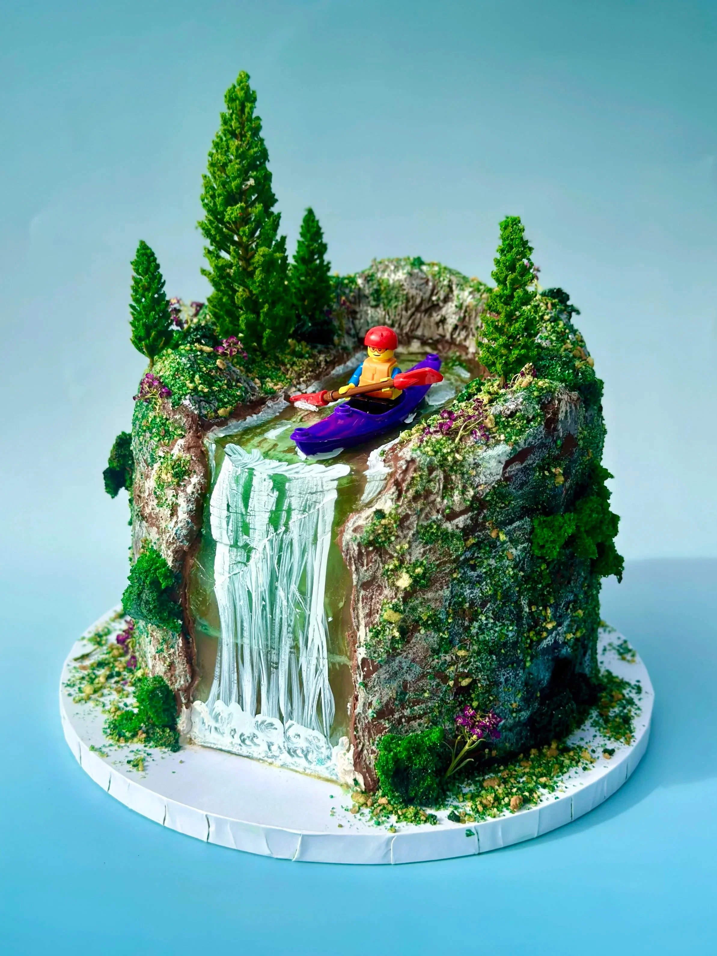 The cake was carved so the lego kayaker could float down an edible jelly waterfall 