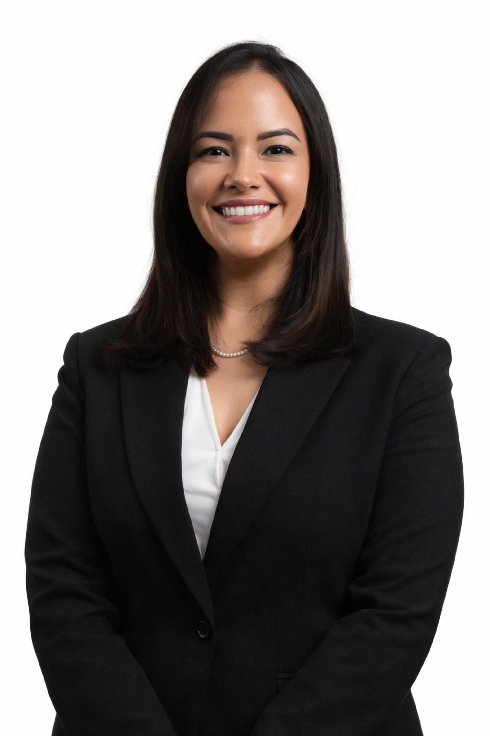 A professional woman with straight black hair wearing a black blazer, white blouse, pearl necklace, smiling with arms crossed against a white background.