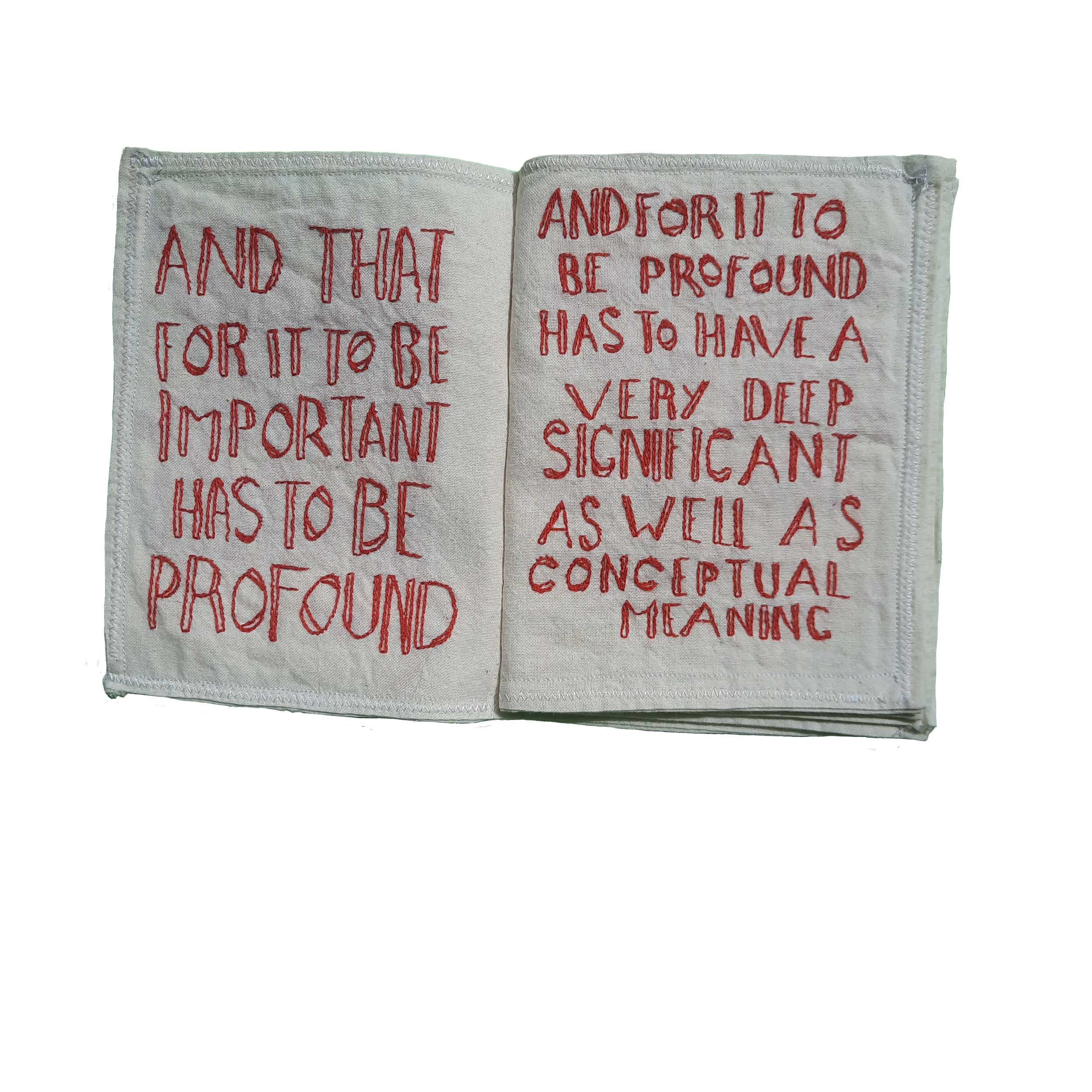 A fabric piece with red embroidered text containing a quote about the importance of humility and introspection.