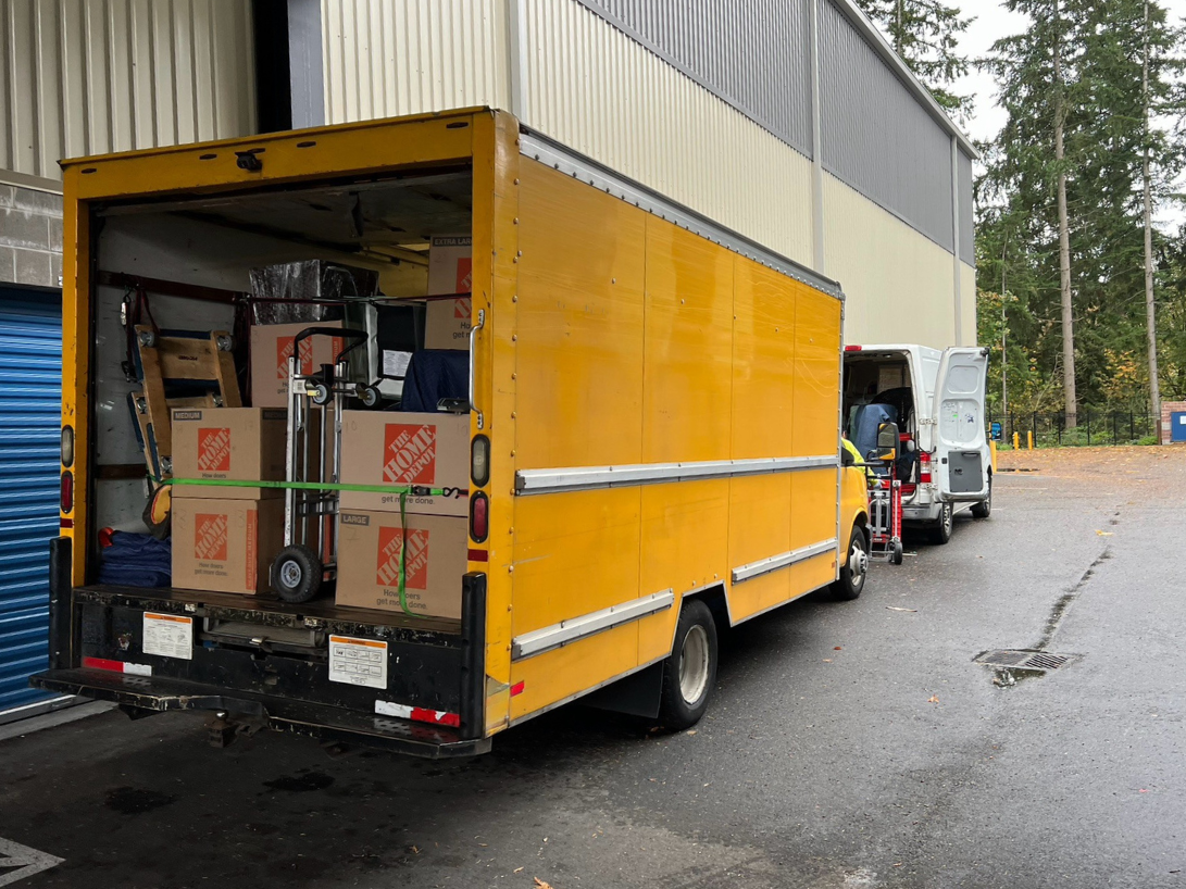 A yellow moving truck filled with moving boxes and materials for another AAA Moving and Delivery team, Serving King and Snohomish County movers