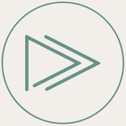 A minimalist icon of two rightward-pointing chevrons inside a circle.