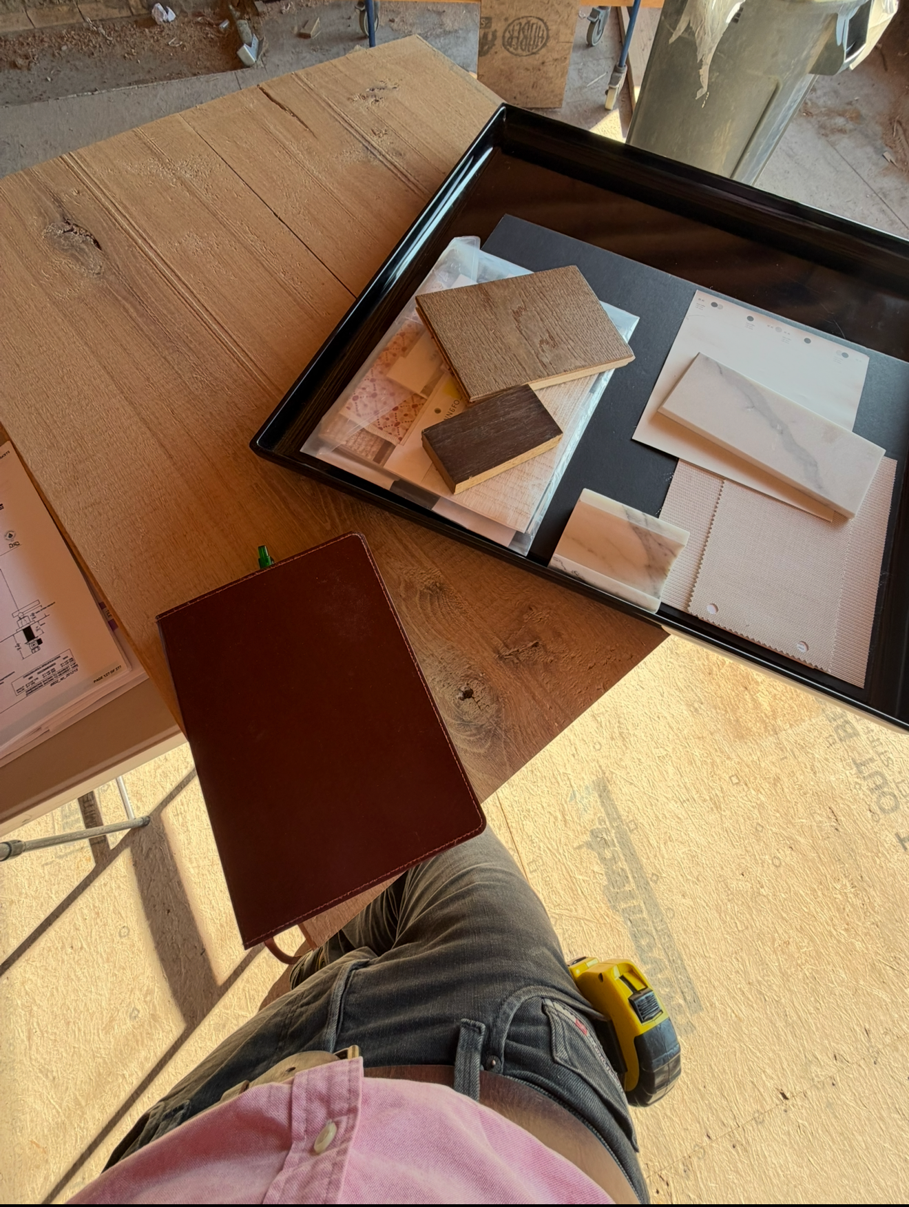 Custom flooring samples and materials being reviewed for a hardwood flooring project.
