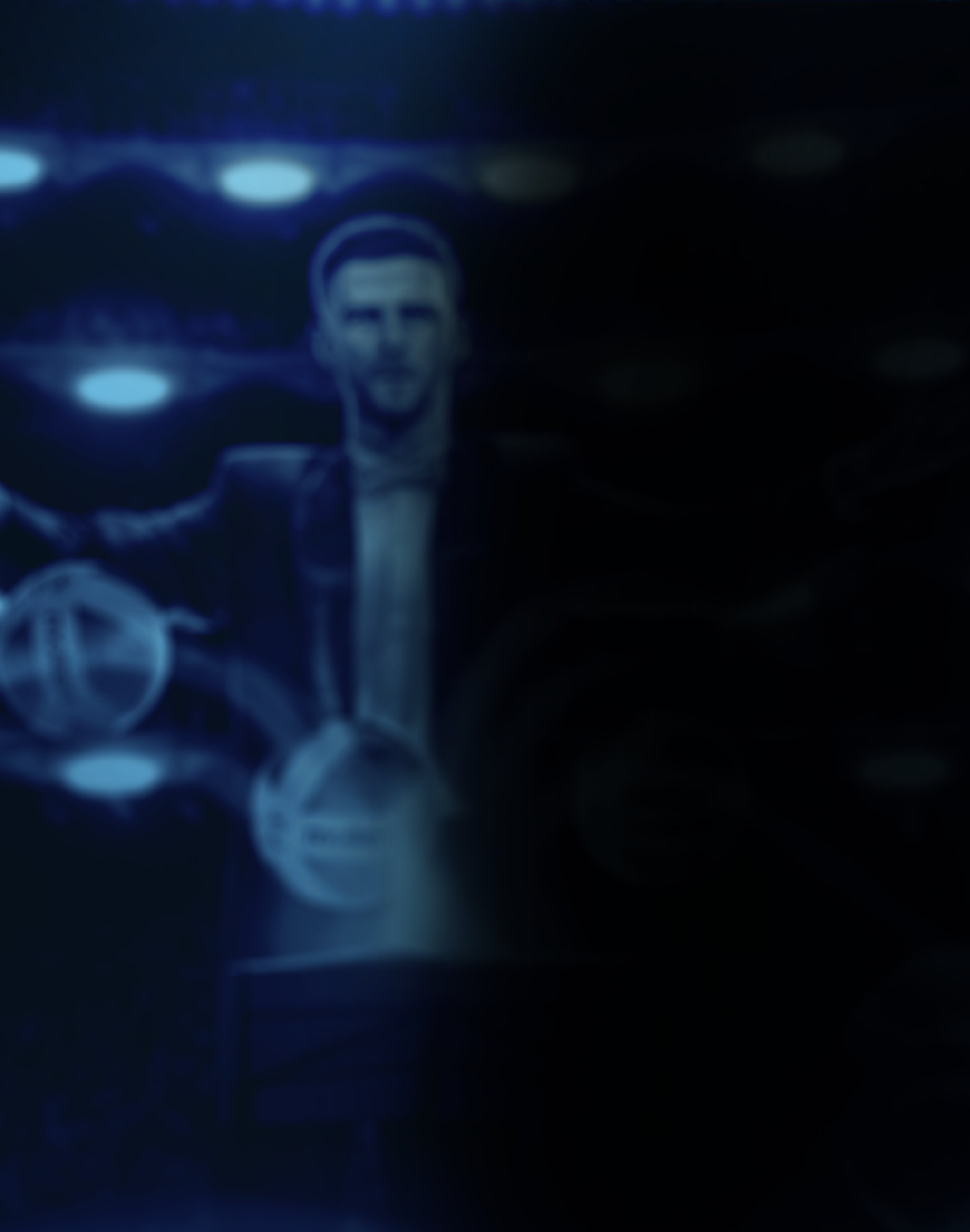 Blurred digital image of a person wearing headphones with a dark background and scattered circular light effects.