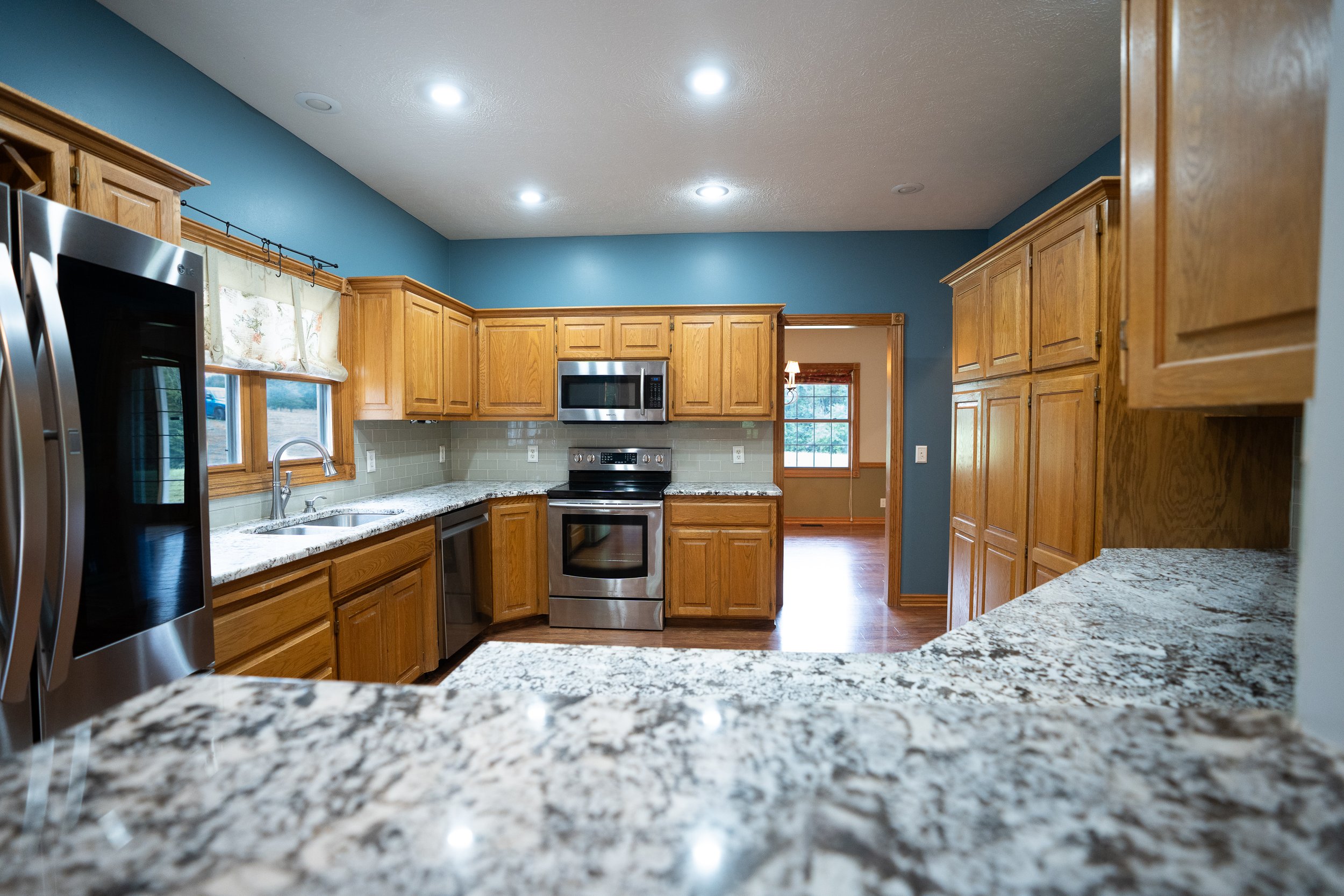Open kitchen with stainless steel appliances and ample cupboard space.