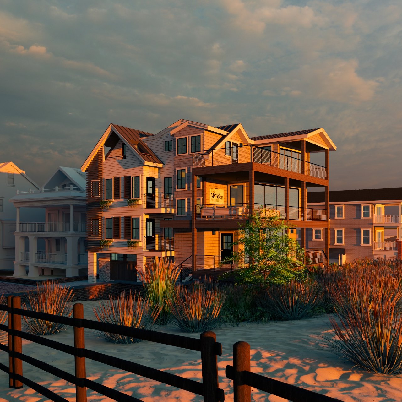 A modern multi-story beachfront house with balconies and large windows, illuminated by sunset, with sandy dunes, beach grass, and a wooden fence in the foreground.