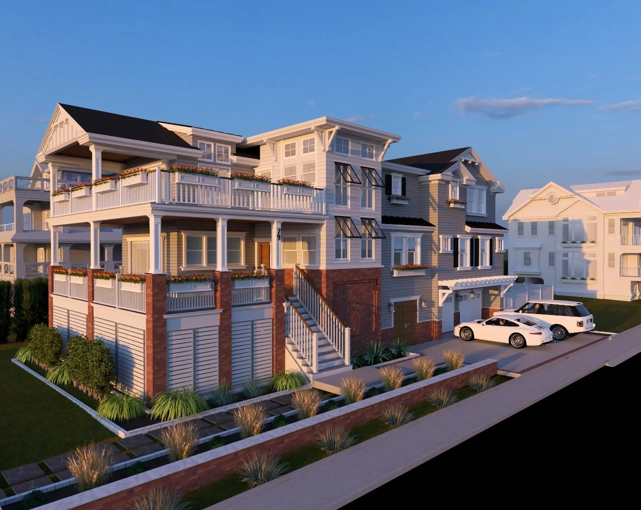 front view of a large, modern multi-story house with white and gray exterior, multiple balconies with flower boxes, and a staircase leading to the front door. There are two parked cars in the driveway and well-maintained landscaping.