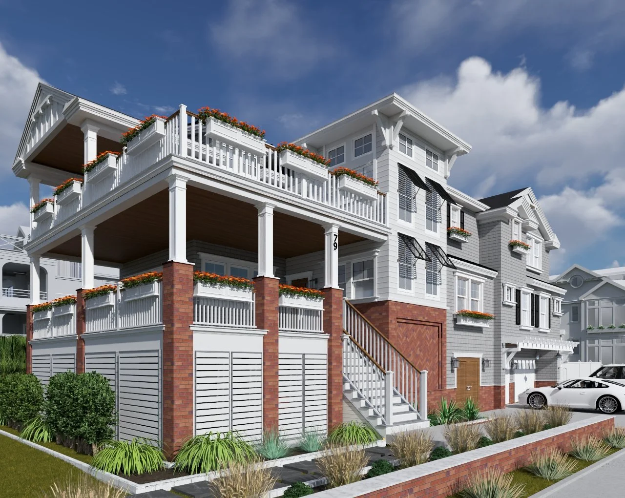 White multi-story house with brick accents, balconies with flower boxes, and a front yard with green shrubs and plants under a partly cloudy sky.