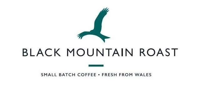 Logo for Black Mountain Roast featuring a stylized bird in flight, with text indicating small batch coffee from Wales.