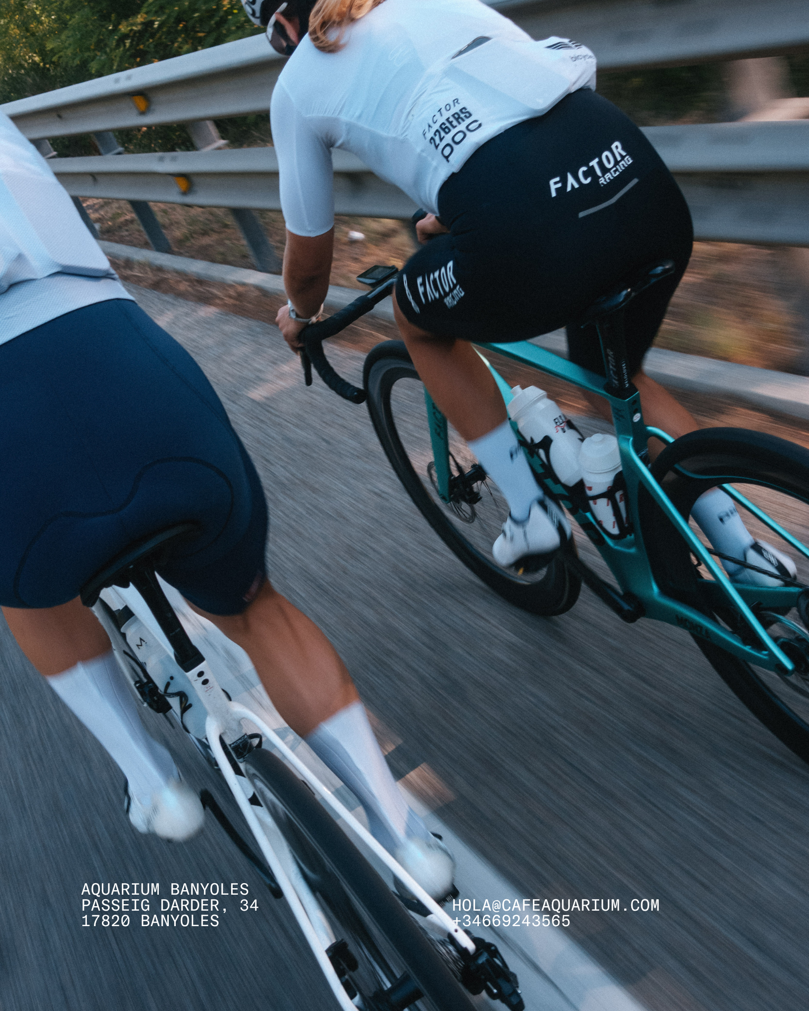 Close-up of a cyclist's lower body riding a bicycle on a road, with text on the image indicating location and contact information for Aquarium Banyoles in Banyoles, Spain.