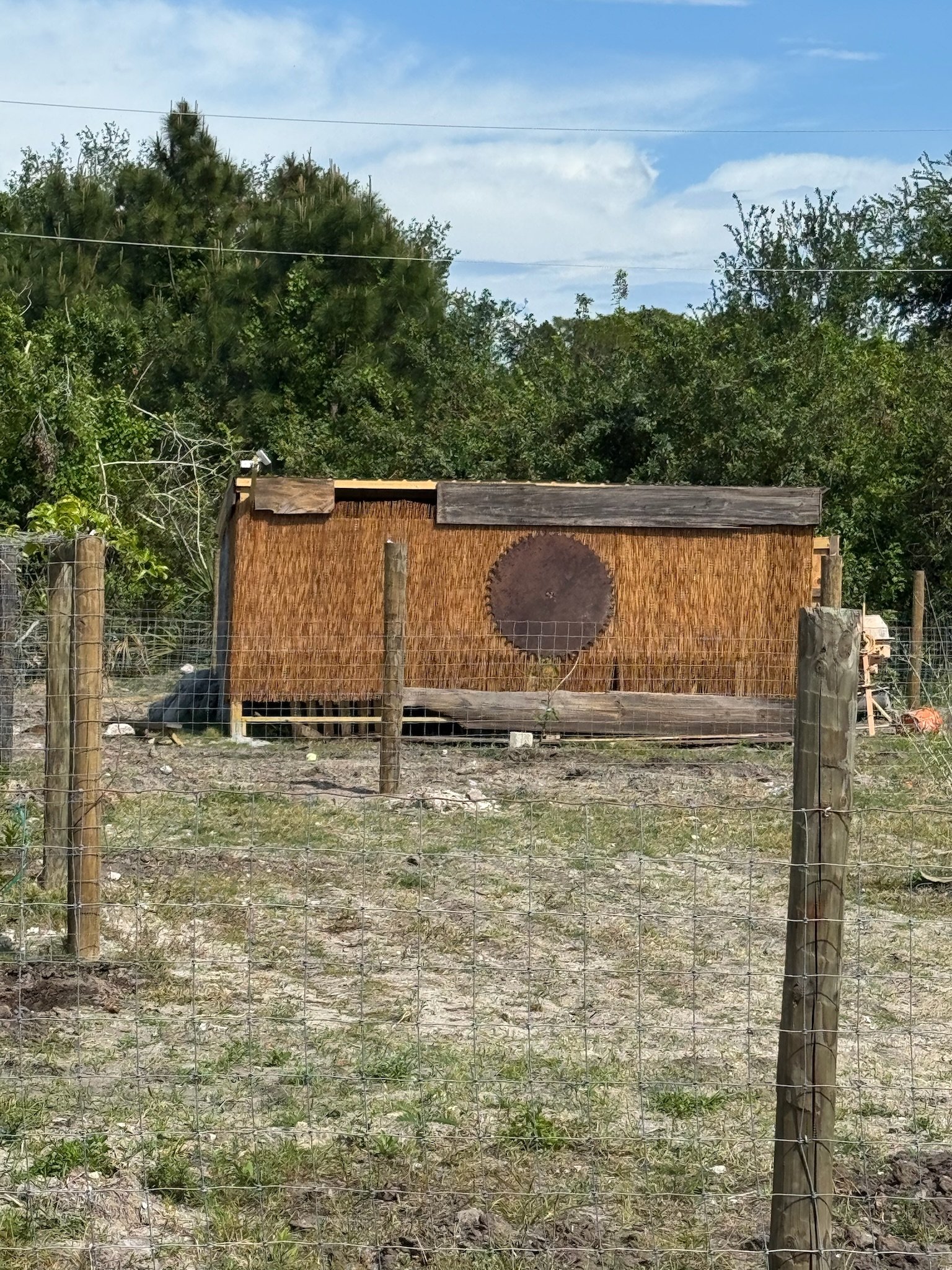 Chicken house at Sawmill Farm with a salvaged circular saw blade mounted on the front
