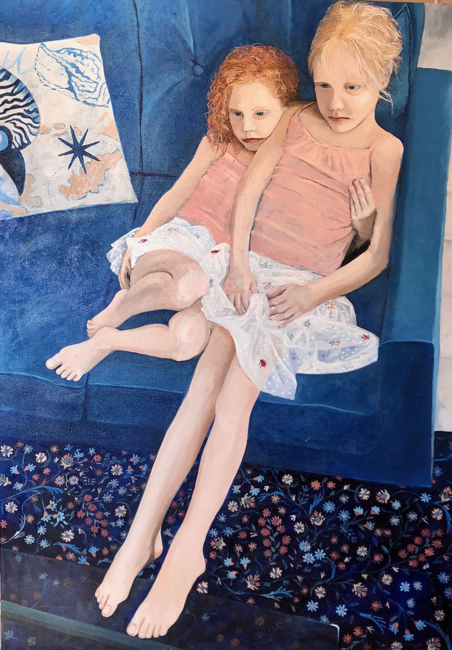 The Girls, an intricate painting of two young girls sitting together on a blue couch by Debbie Lindsey.