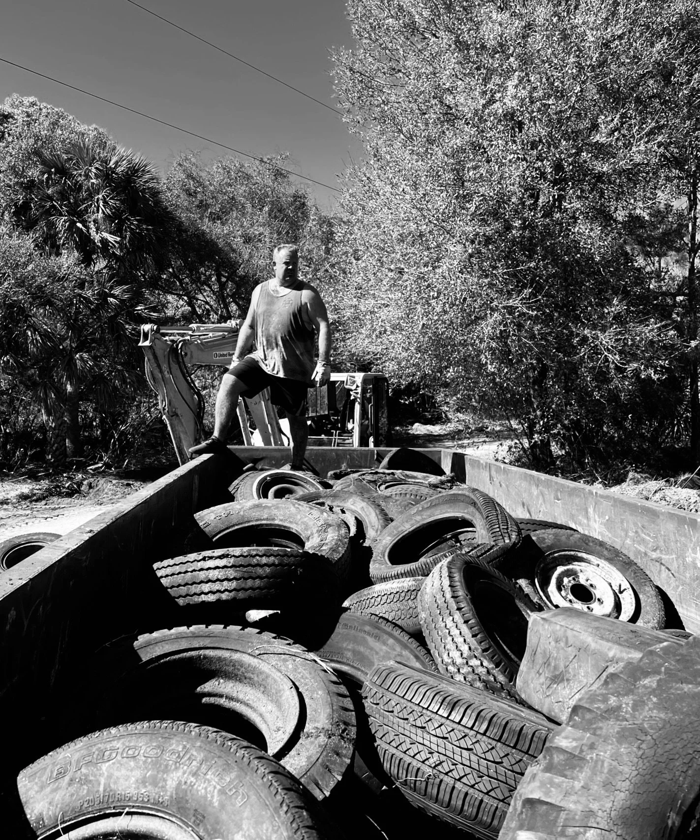 Removing a large pile of discarded tires while clearing the overgrown Sawmill Farm property