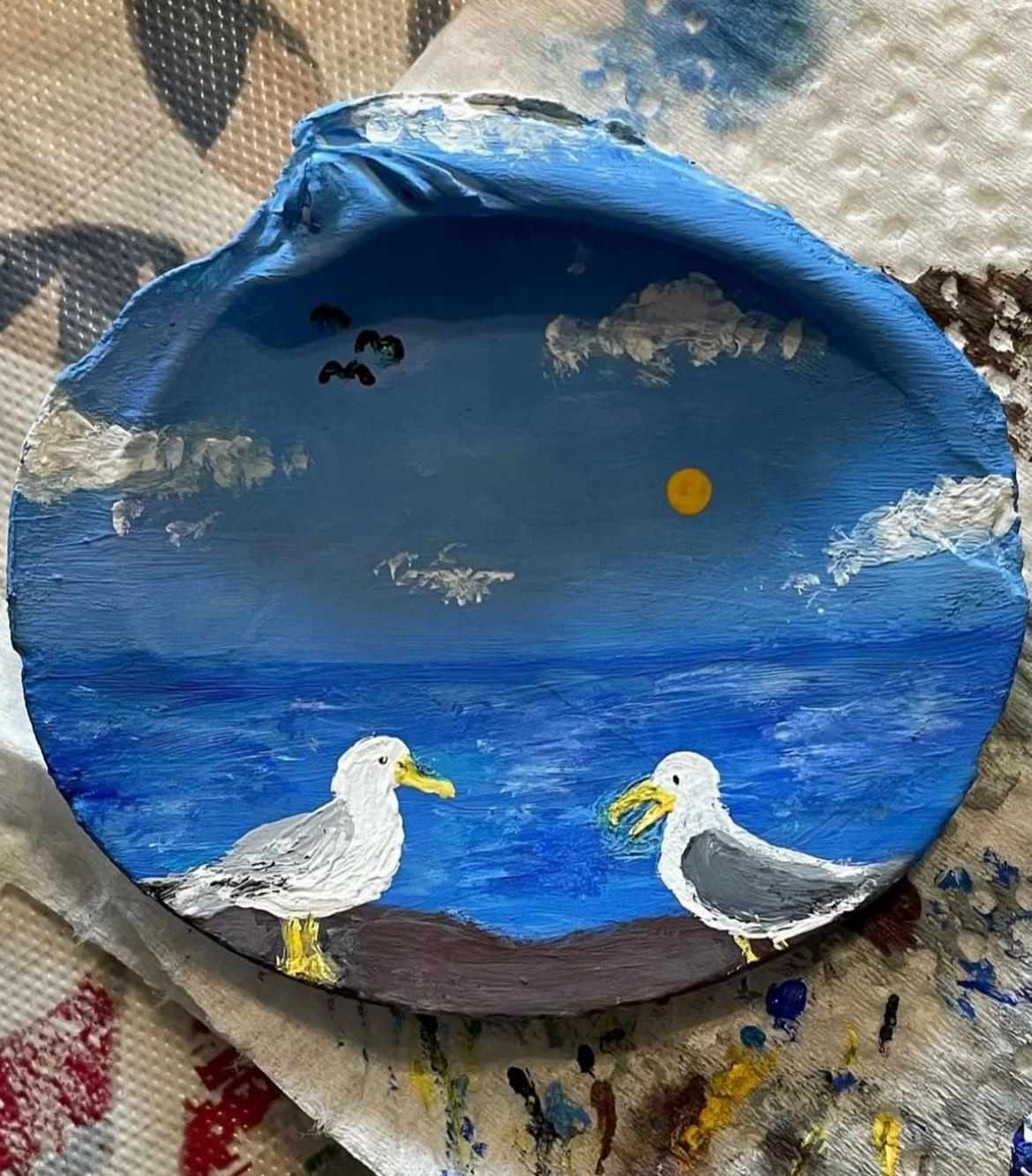 Small acrylic painted shell of two seagulls