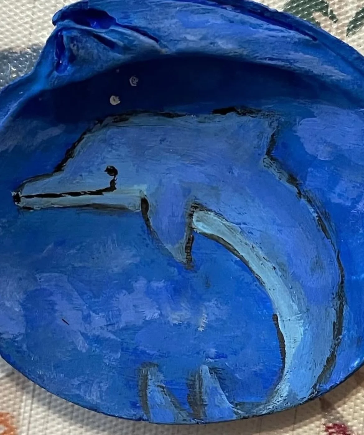 Small acrylic painted shell of a dolphin