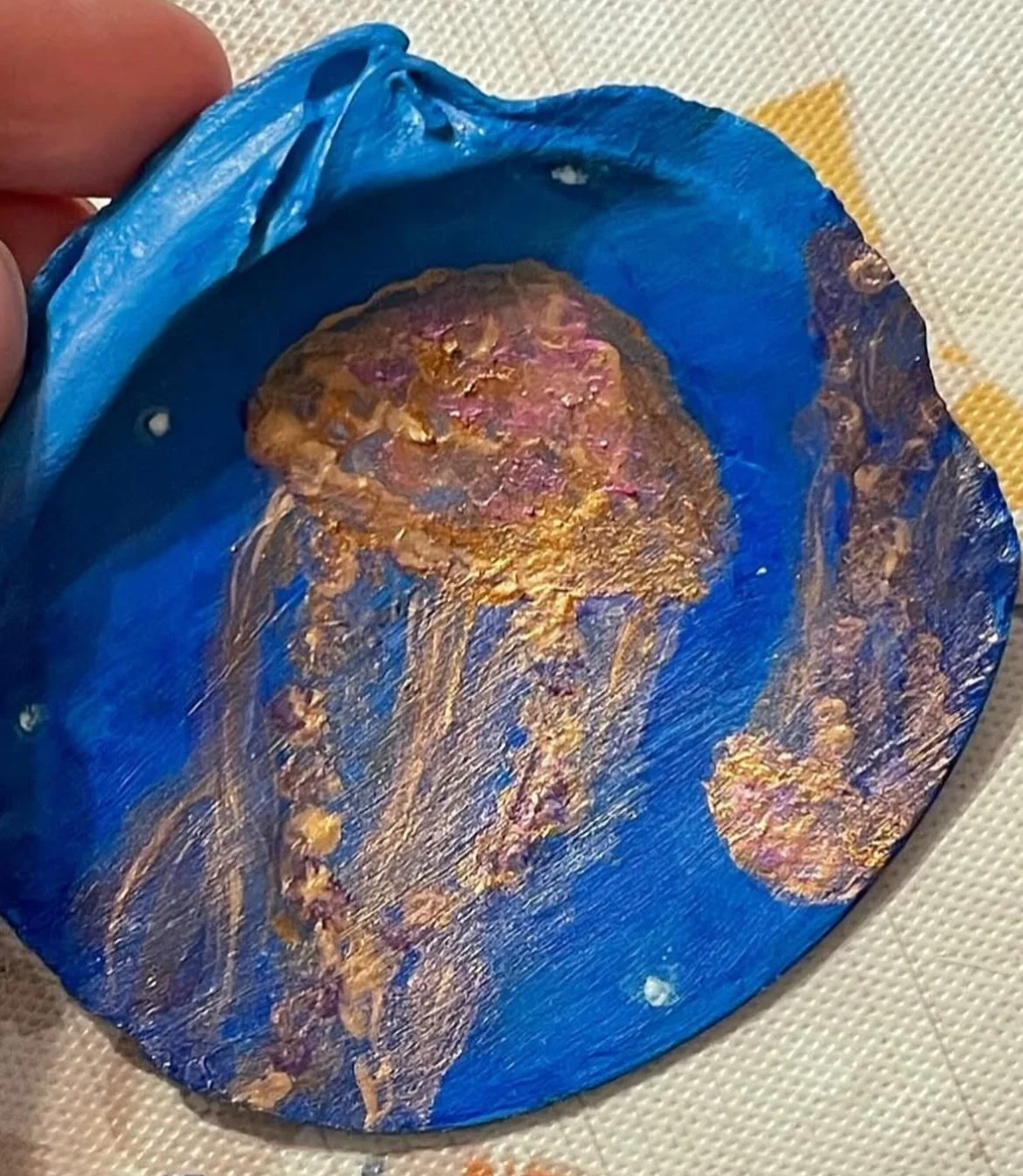 Small acrylic painted shell of two jellyfish