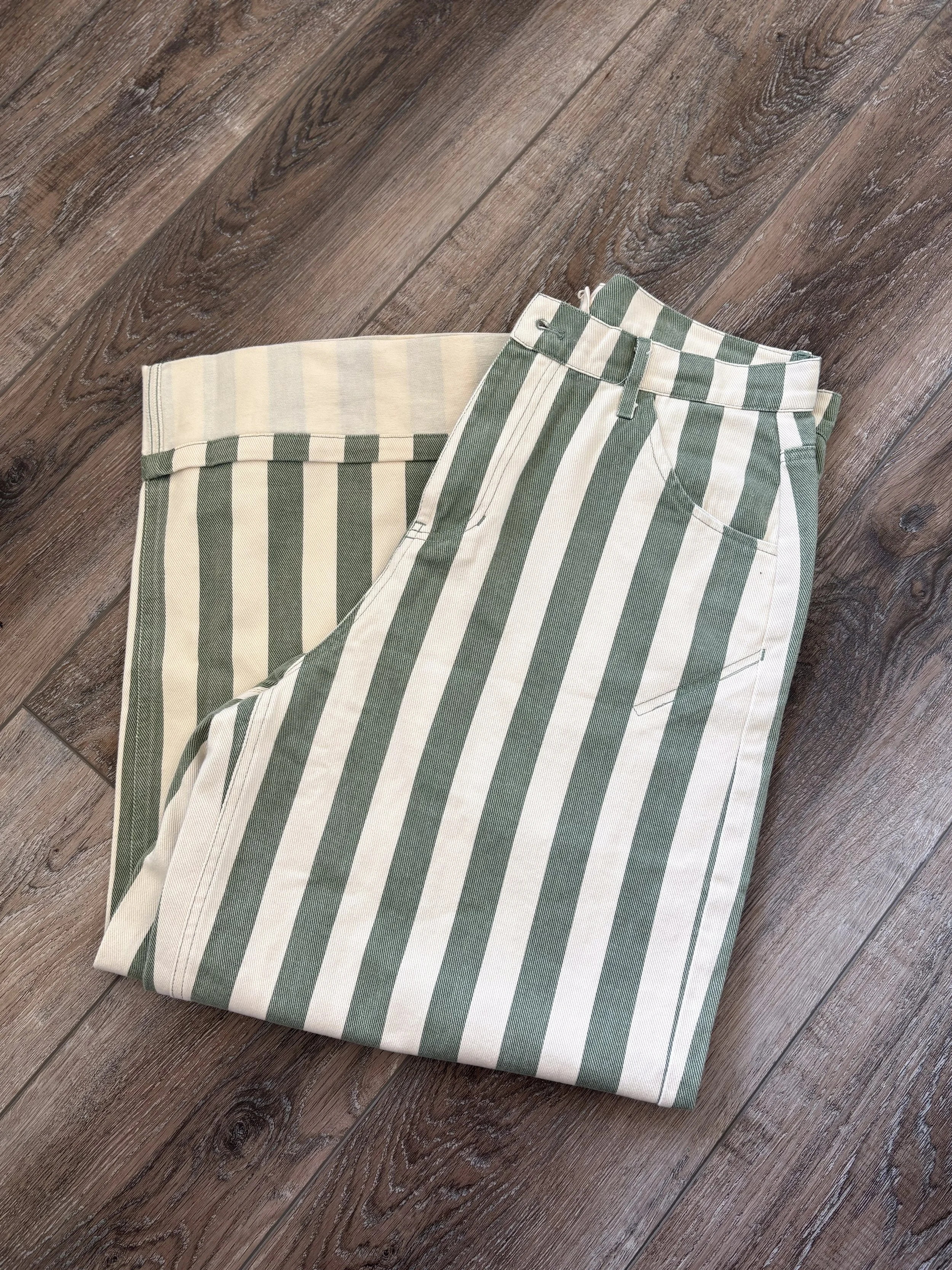 A pair of striped pants on a wooden floor.