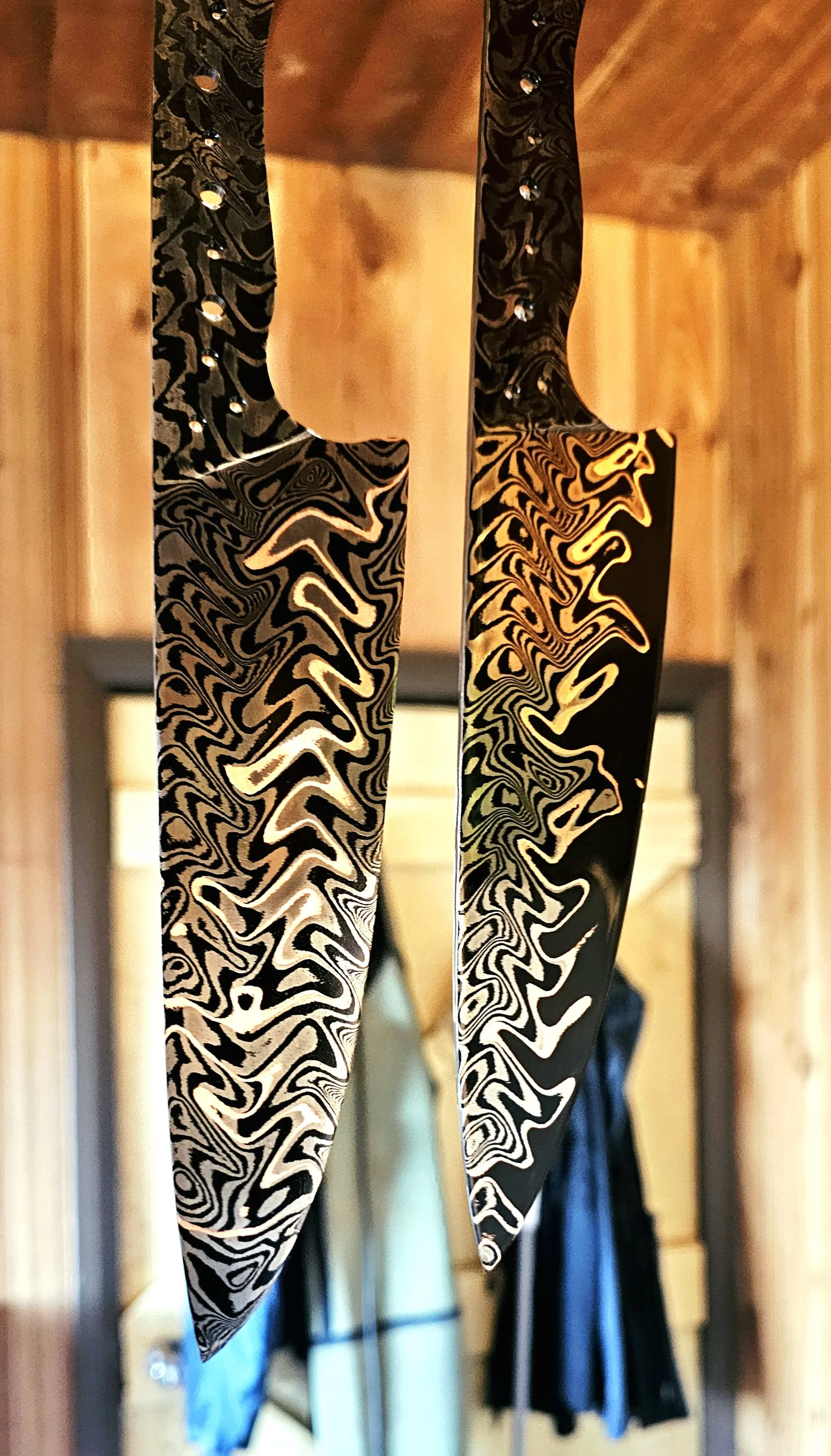 2 Beautiful Copper Damascus blades are hanging after etching in ferric chloride