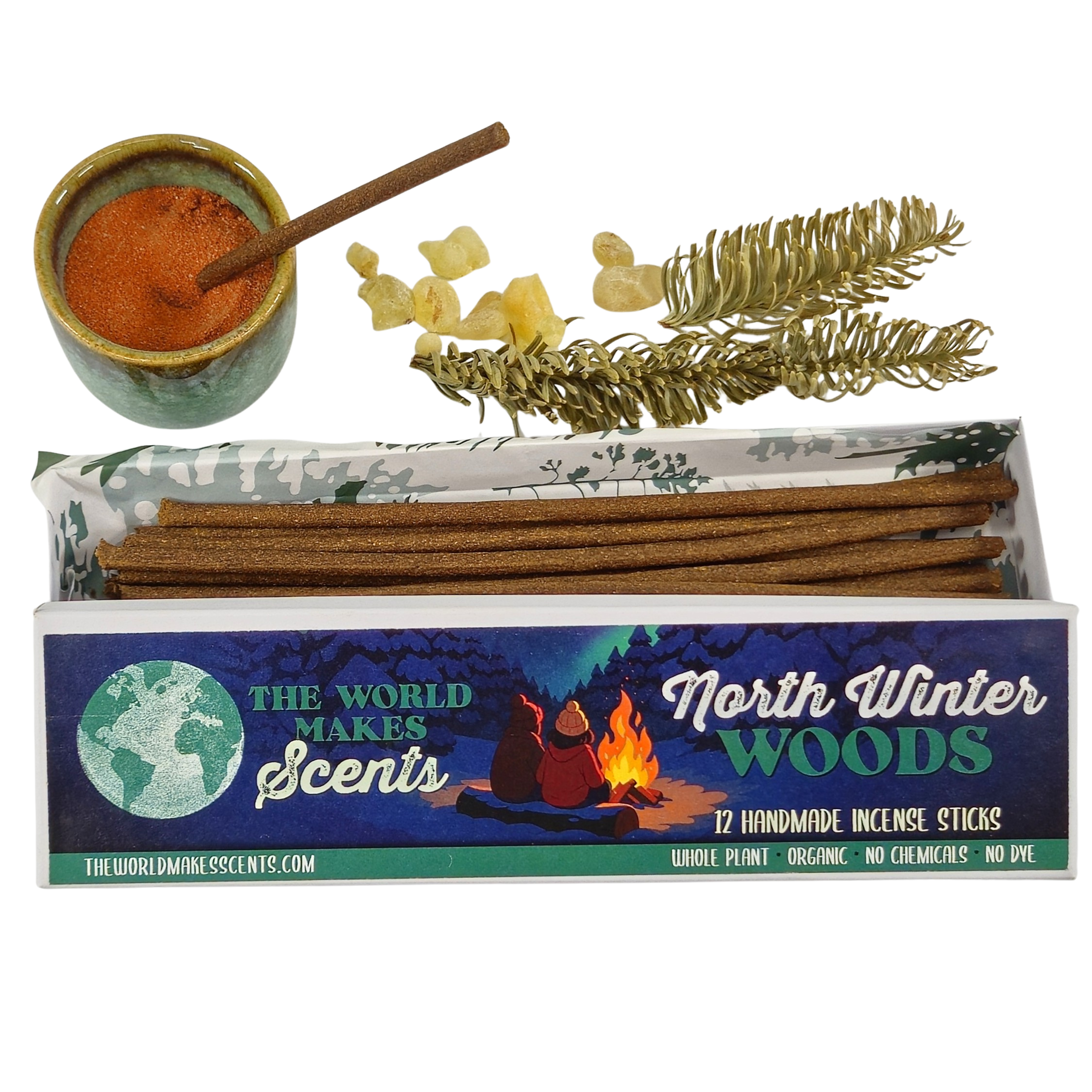 Close-up of a box of incense sticks with a colorful label reading "The World Makes Scents North Warts Whole Plant Organic No Chemicals No Dye 12 Handmade Incense Sticks" featuring an illustration of a campfire and two people sitting around it.