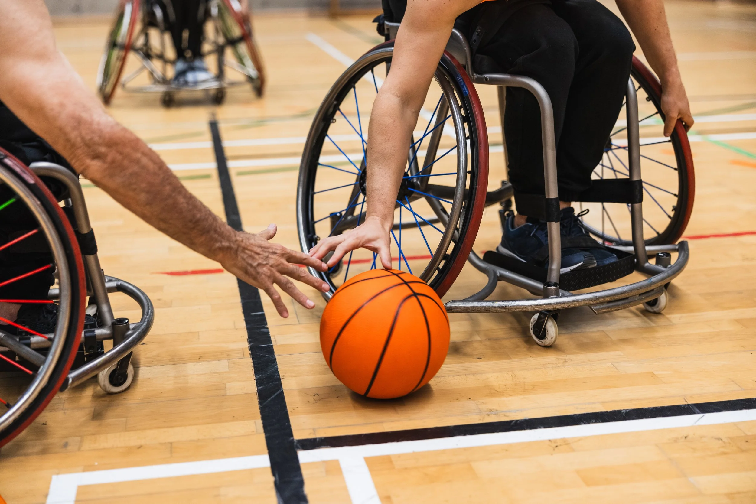 Two guys in a wheelchair playing basketball