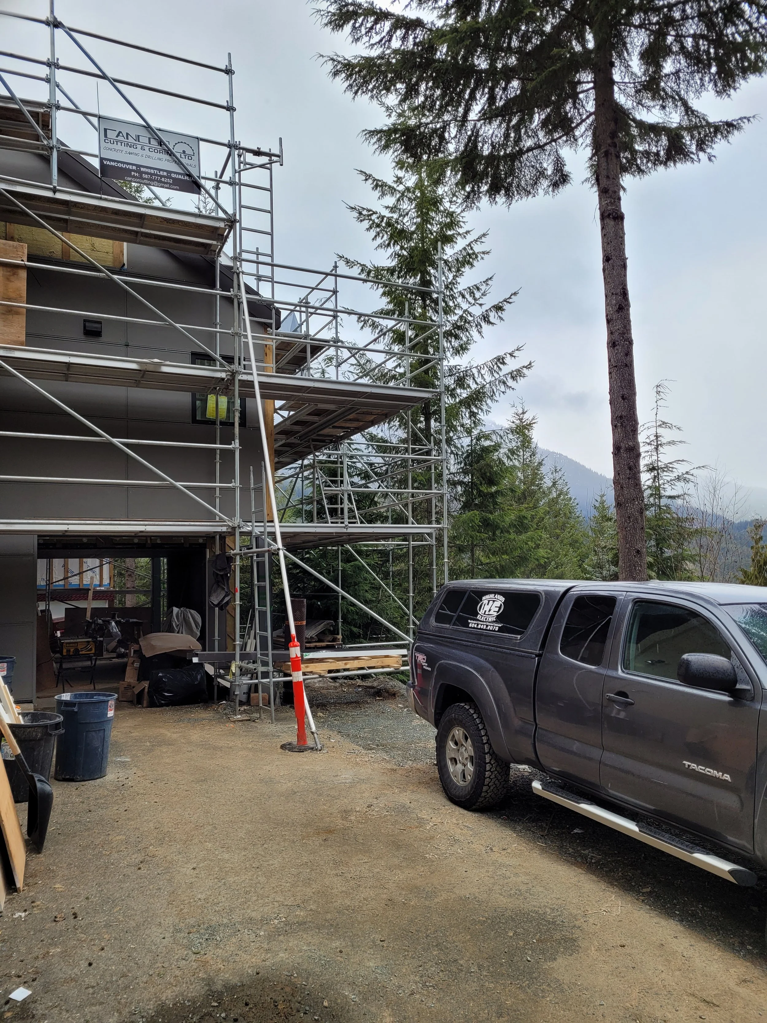 Scaffolding and construction equipment on a custom home build site in Whistler
