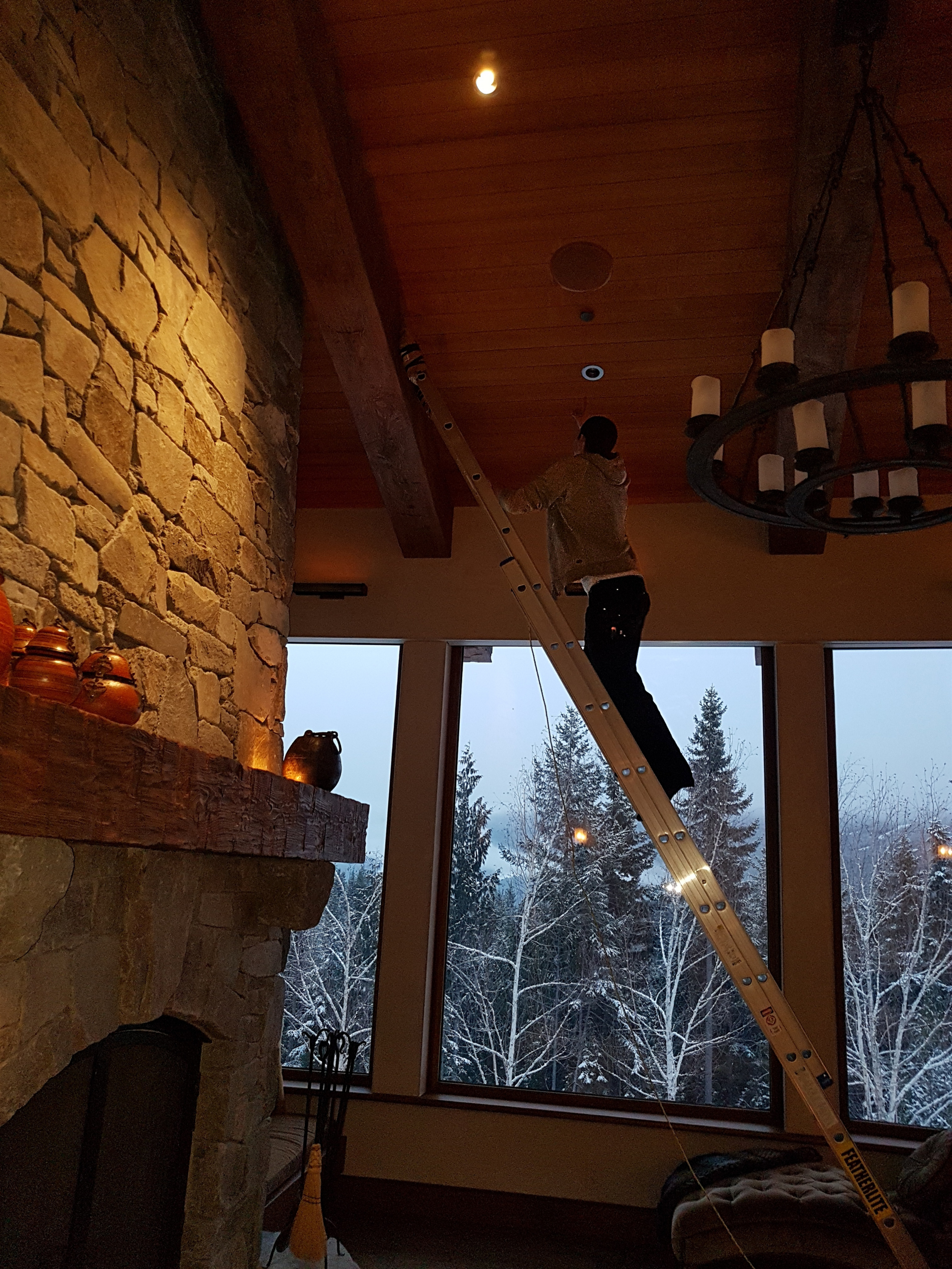 Custom lighting installation in a stone fireplace living space