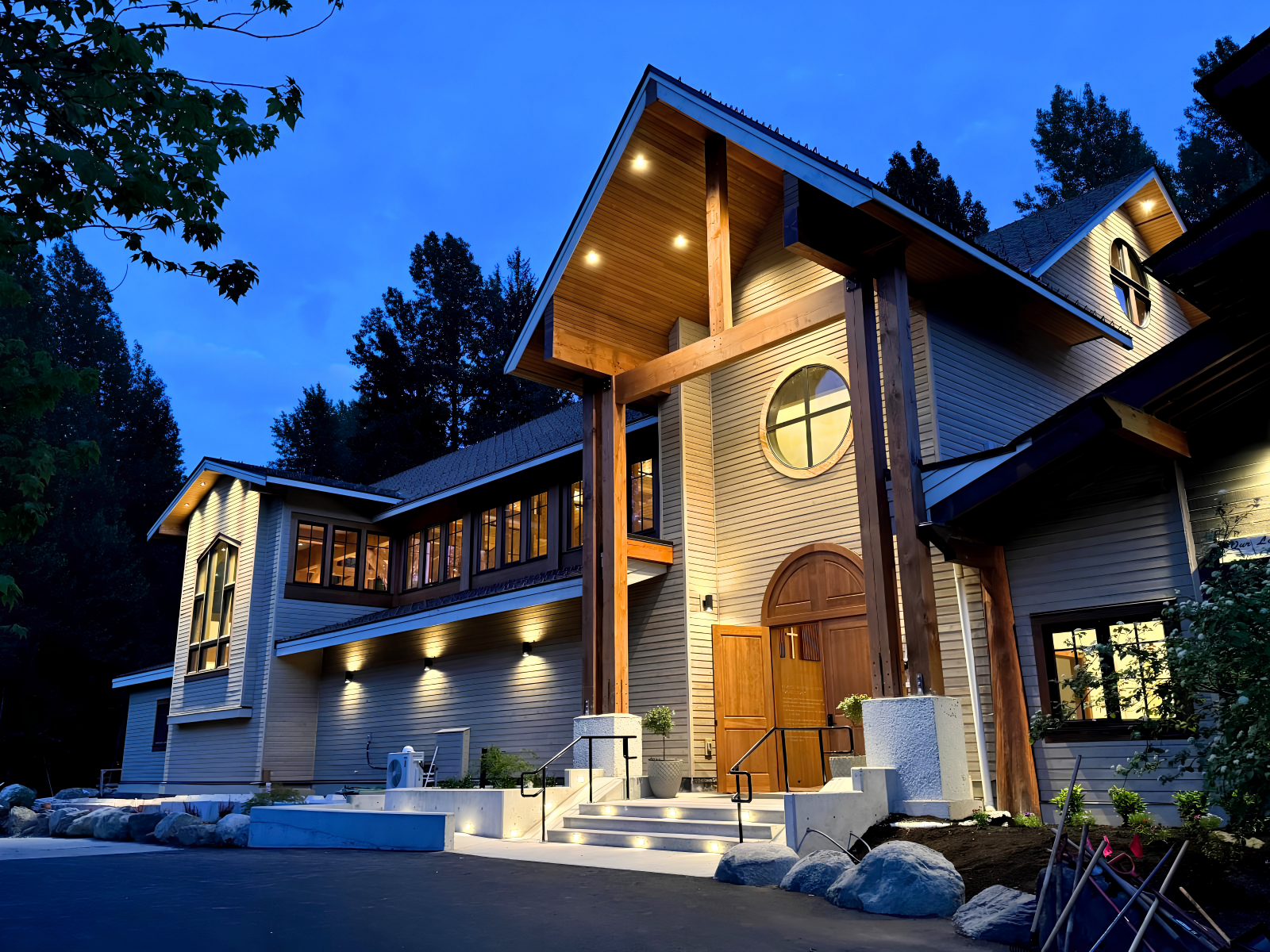 Exterior lighting design on a timber and stone lodge entrance, Whistler