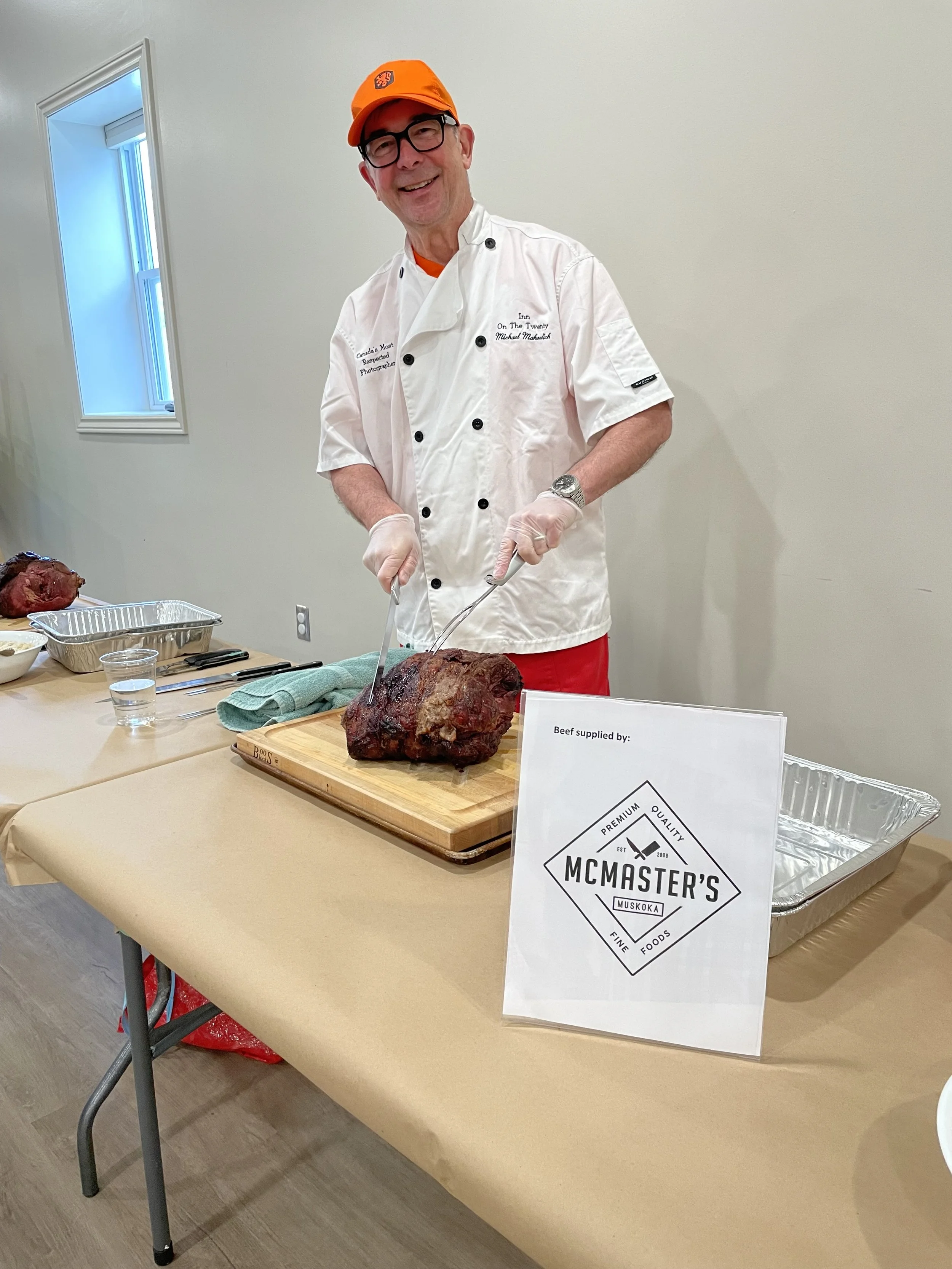 Michael carving beef at the surf and turf charity event