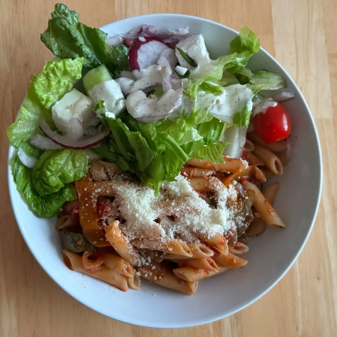 Ratatouille on pasta, topped with Parmesan. With a Greek salad

A friend from work suggested ratatouille to use up my courgettes- I made this one in the slow cooker- it was so good! 
I left out the aubergine as I didn&rsquo;t have any. 

#ratatouille