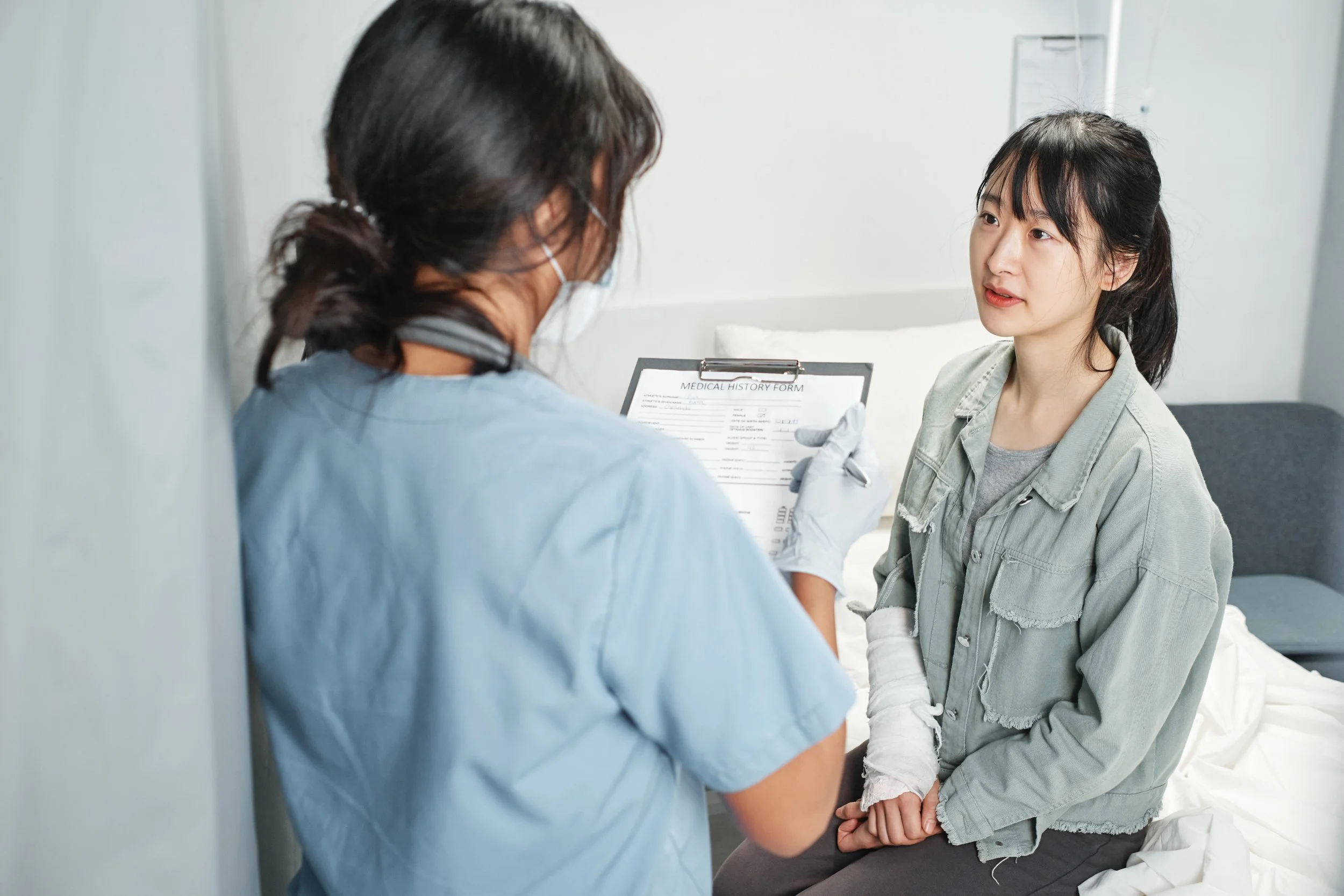 Female patient speaking with a healthcare provider during a medical visit, representing preventive care, sick visits, and ongoing primary care services in Northern Nevada.