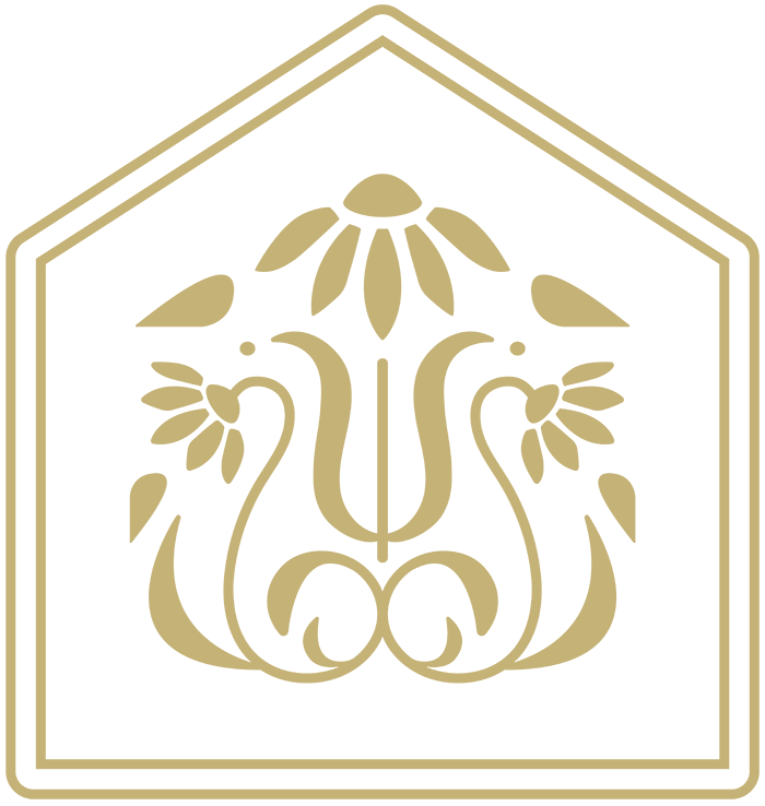A decorative emblem featuring a stylized floral design with a house-like outline in gold on a black background.